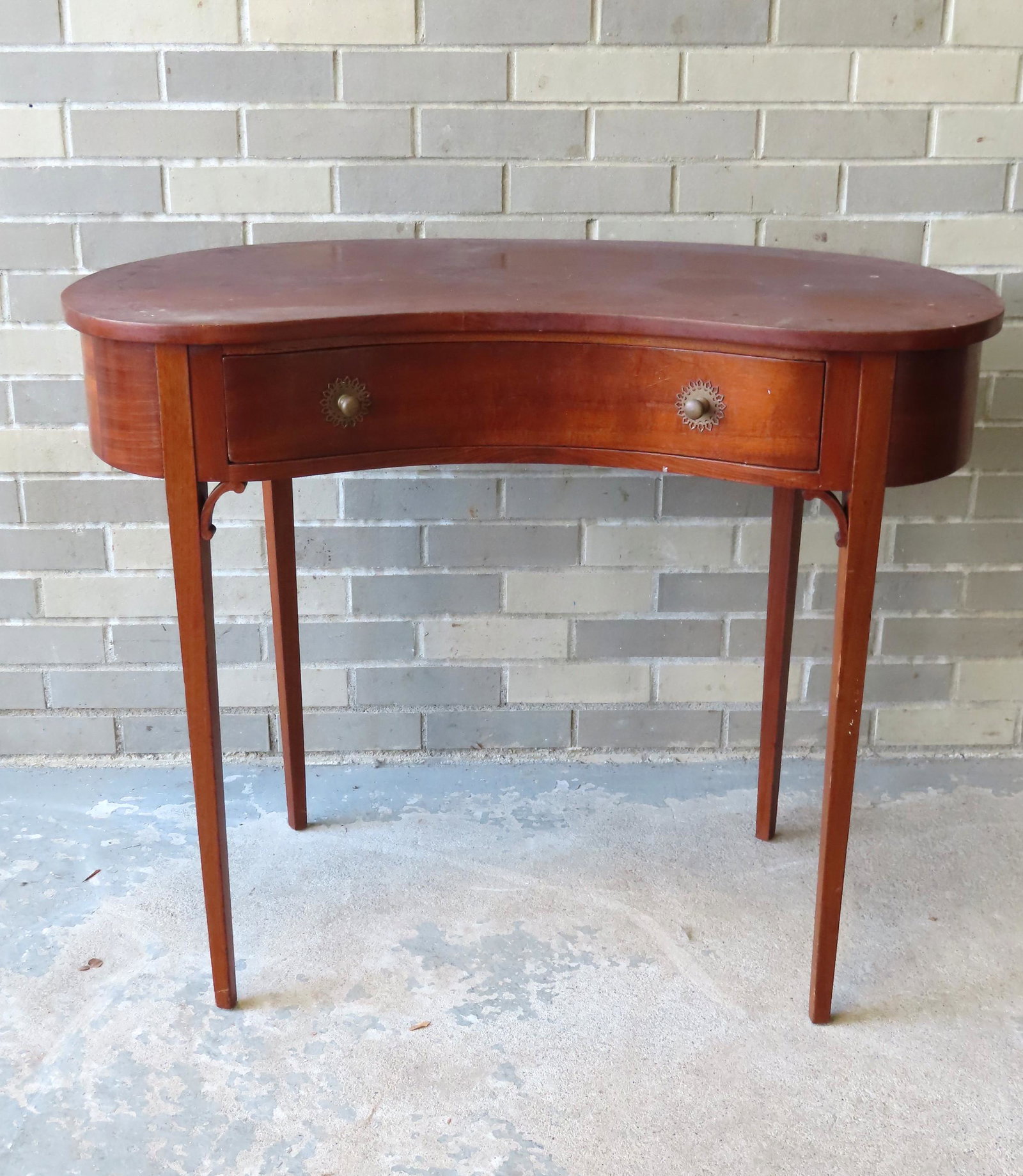 A custom made Hepplewhite style kidney shaped mahogany: A custom made Hepplewhite style kidney shaped mahogany desk with dovetailed drawer and original fancy brass pulls, late 19th century. Attic found with grime on top and needs cleaning, but structurally