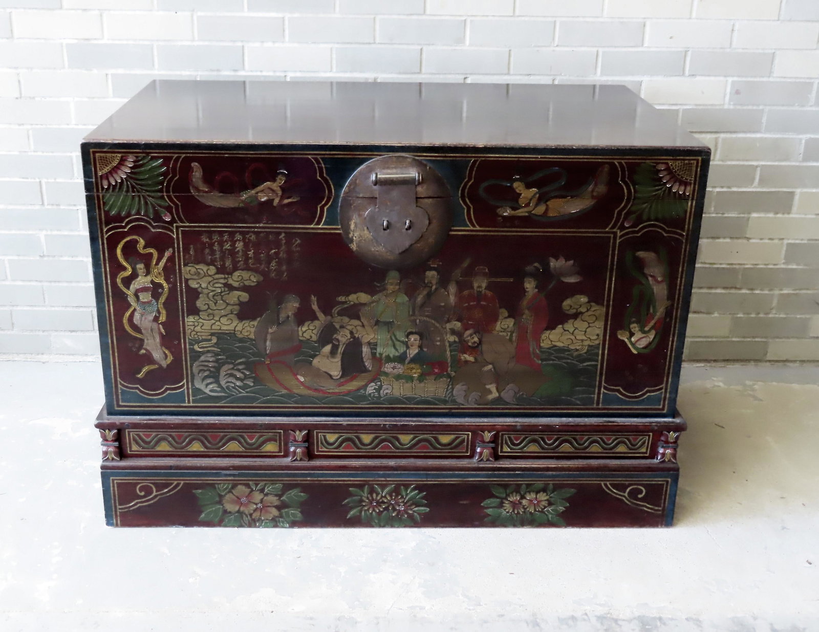 Large hand painted oriental blanket chest with hand: Large hand painted oriental blanket chest with hand forged iron handles and latch. The front panel depicts oriental figures/family that is boarded by mermaids - floral decorations are painted on the b