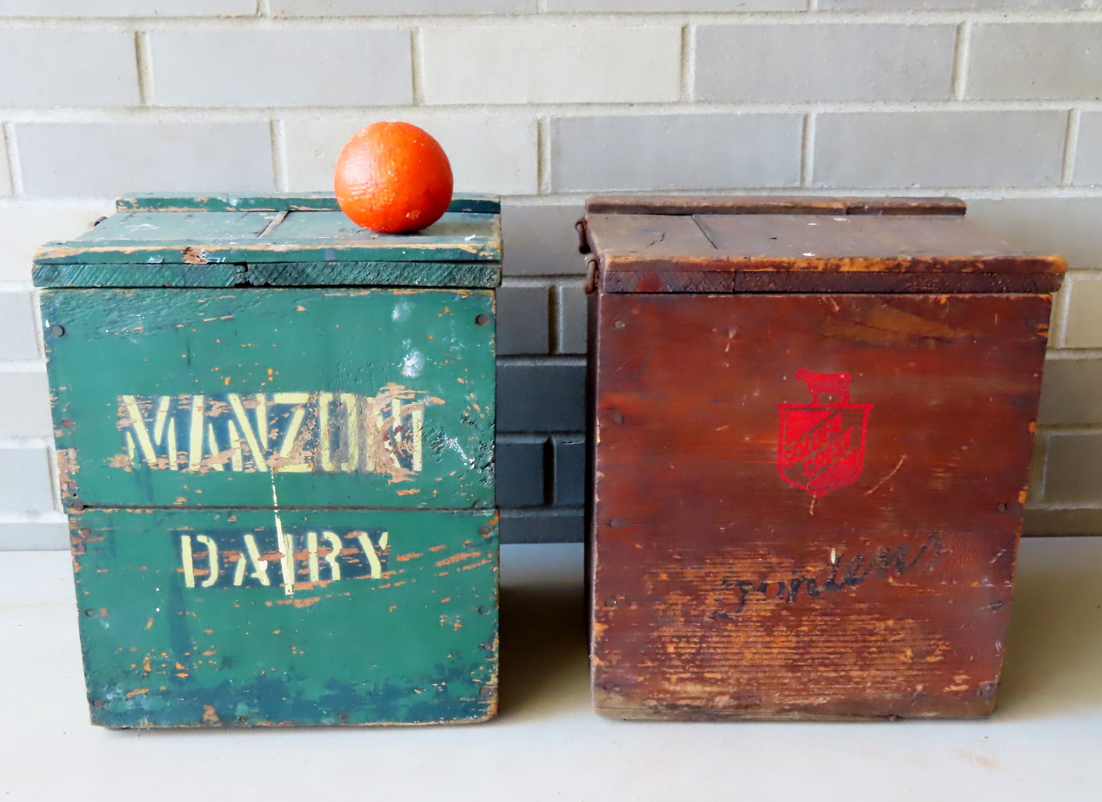 Two painted advertising milk crates including: Borden's: Two painted advertising milk crates including: Borden's milk crate marked on inside of lid "Mf'd for Borden's by Industrial Home For The Blind / Brooklyn N.Y." - 10 1/2"W x 9 1/4"D x 12"H - circa 1930