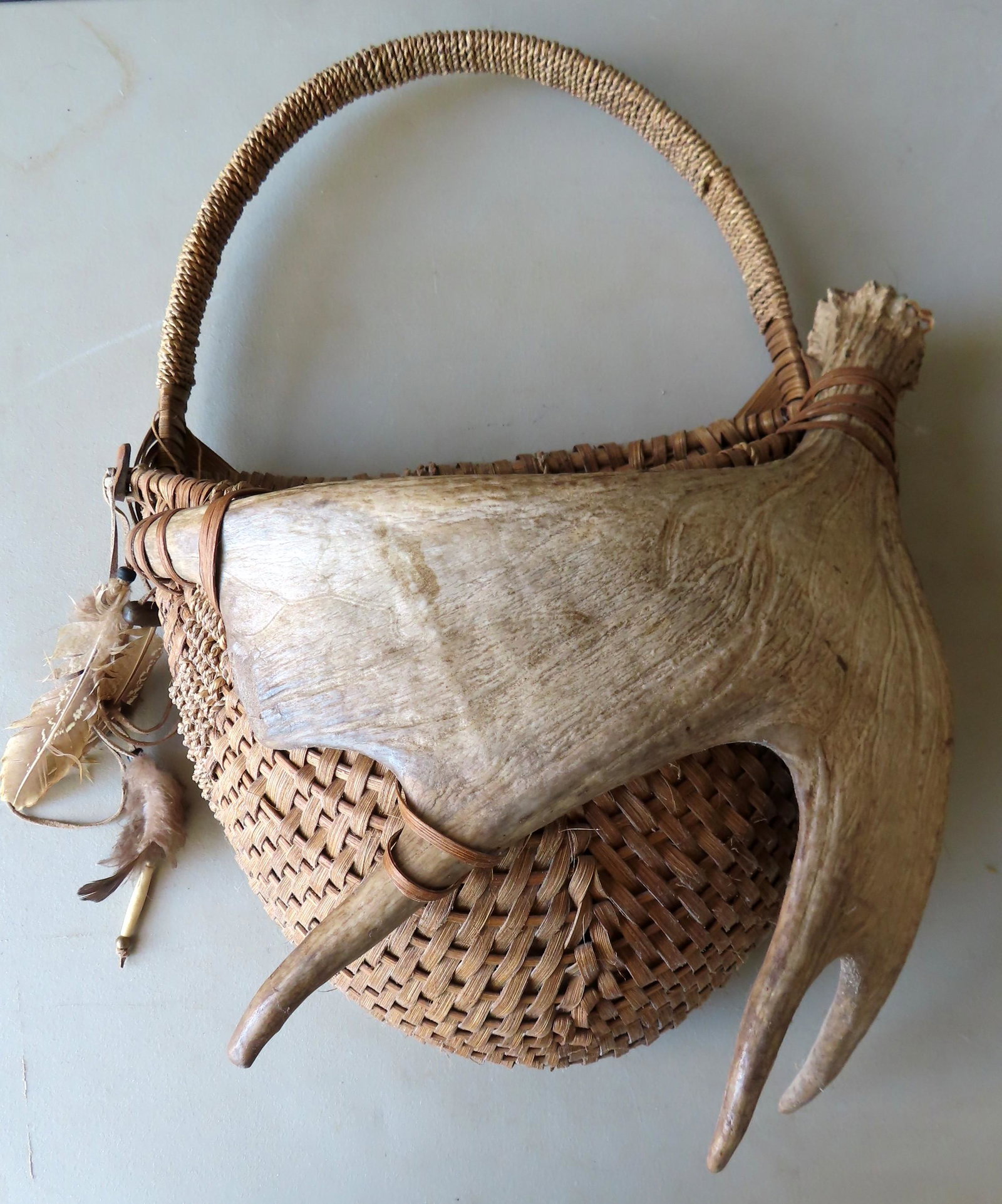 Modern decorative hand woven wall basket, melon type,: Modern decorative hand woven wall basket, melon type, with attached moose horn. Original paper label from "Eagle Rock Baskets". Very good condition. 22"H x 16"W. Third quarter 20th century.