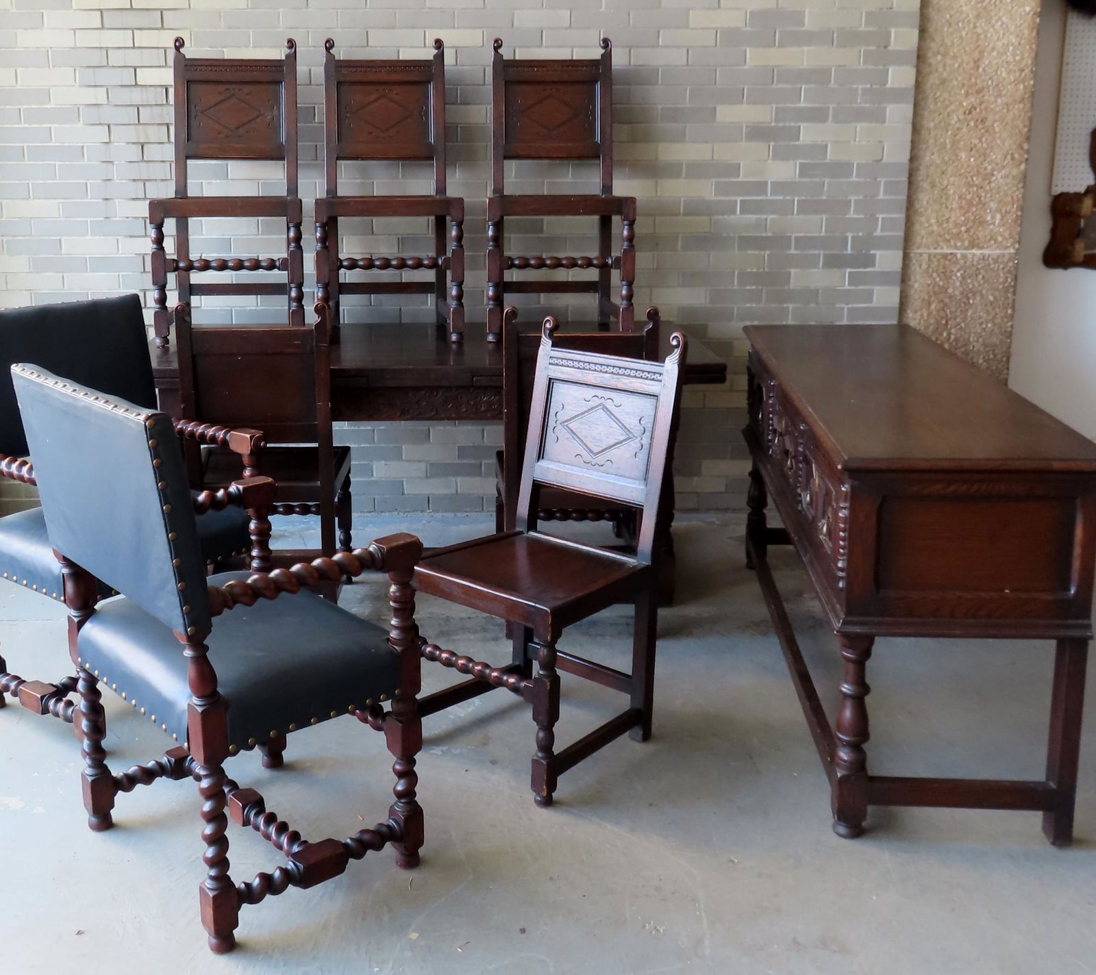 A good oak Jacobean style dining room set by the: A good oak Jacobean style dining room set by the Kensington Furniture Company NY City - manufacturers paper labels on each piece (see photos). The set consists of a refractory table, 8 chairs (6 match