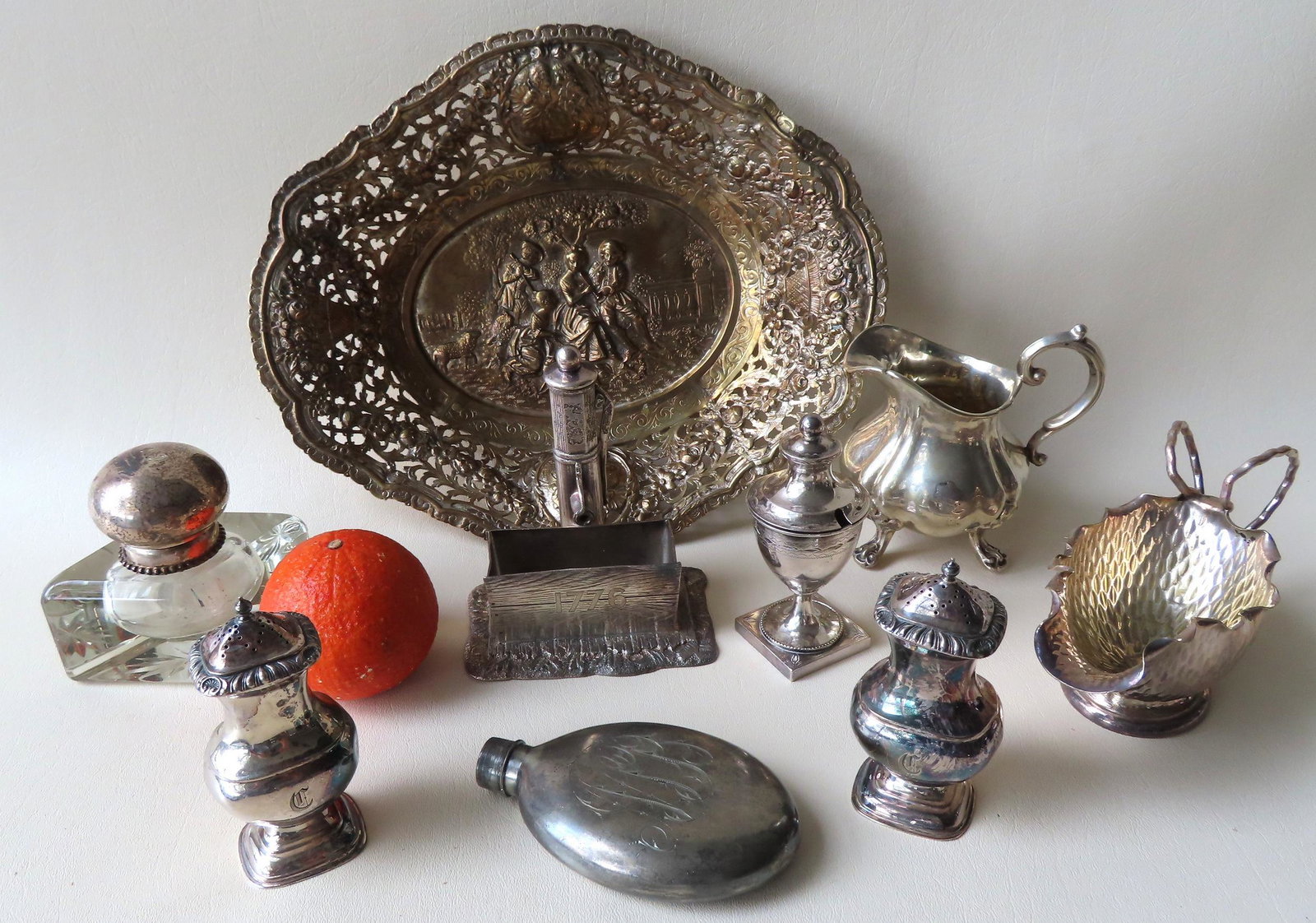 A grouping of 8 decorative silver objects including: A: A grouping of 8 decorative silver objects including: A commemorative silver water pump attached to a rectangular trough engraved 1776 - the base signed James W. Tuft Co. / Boston / Warranted Triple Pl