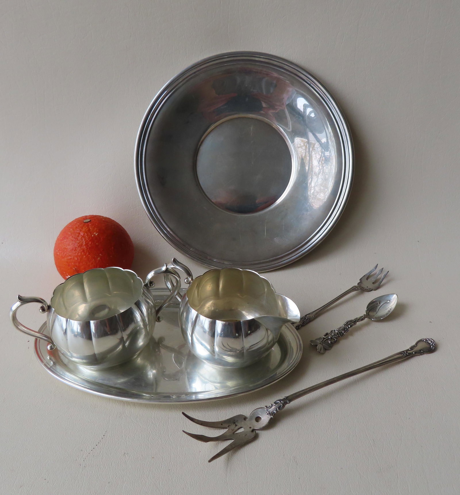 Grouping of 7 pieces of sterling silver including a: Grouping of 7 pieces of sterling silver including a Gorham sugar, creamer and under plate - each with small ding, else good condition; a Gorham plate - 9" diameter - good condition; and 3 serving piec