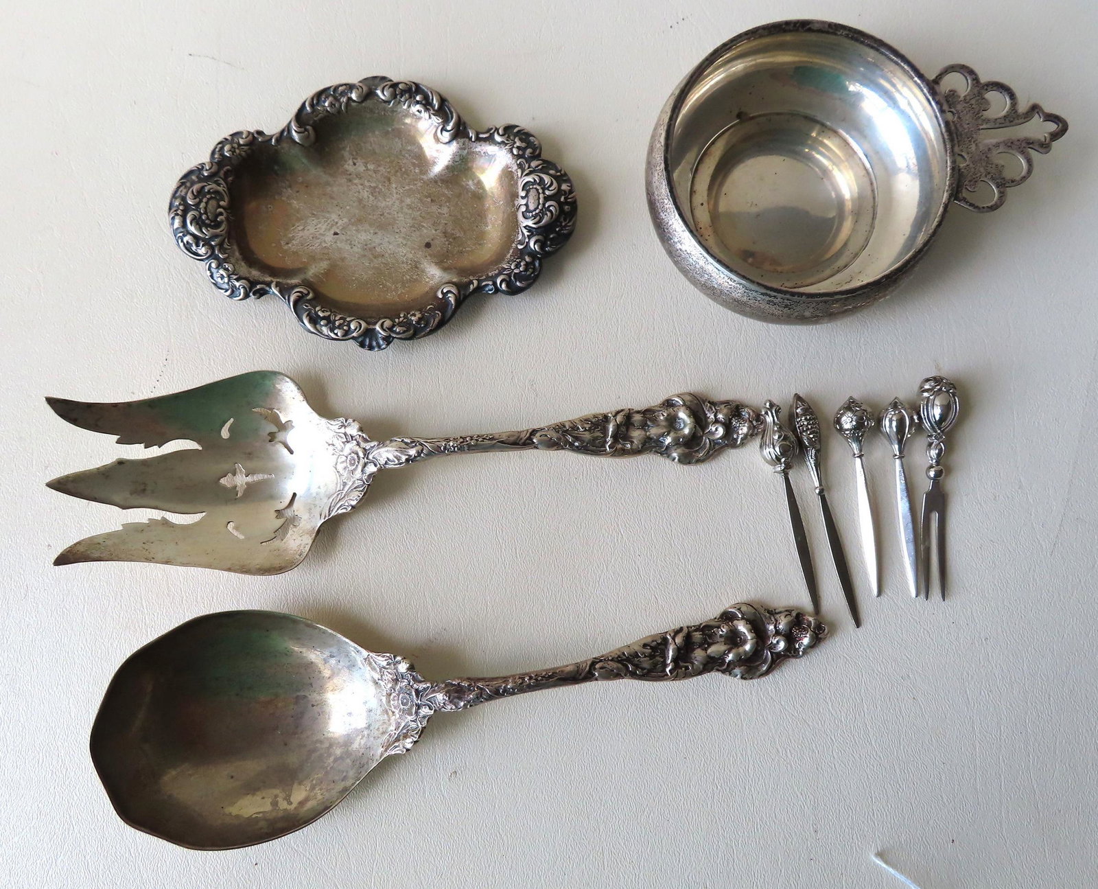 Grouping of sterling silver collectibles including: An: Grouping of sterling silver collectibles including: An outstanding salad set consisting of serving spoon and fork with heavily embossed handles that are marked Sterling (maker's mark not present) - pr