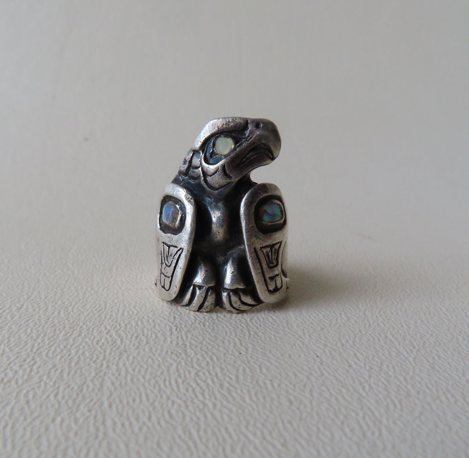 Patty Fawn, 20/21st Century, active/lives in: Patty Fawn, 20/21st Century, active/lives in Washington. Northwest coast sterling silver ring in the form of an eagle with abalone shell inlay, signed "#10 Patty Fawn" - Gross weight of 1.48 ozt. Note