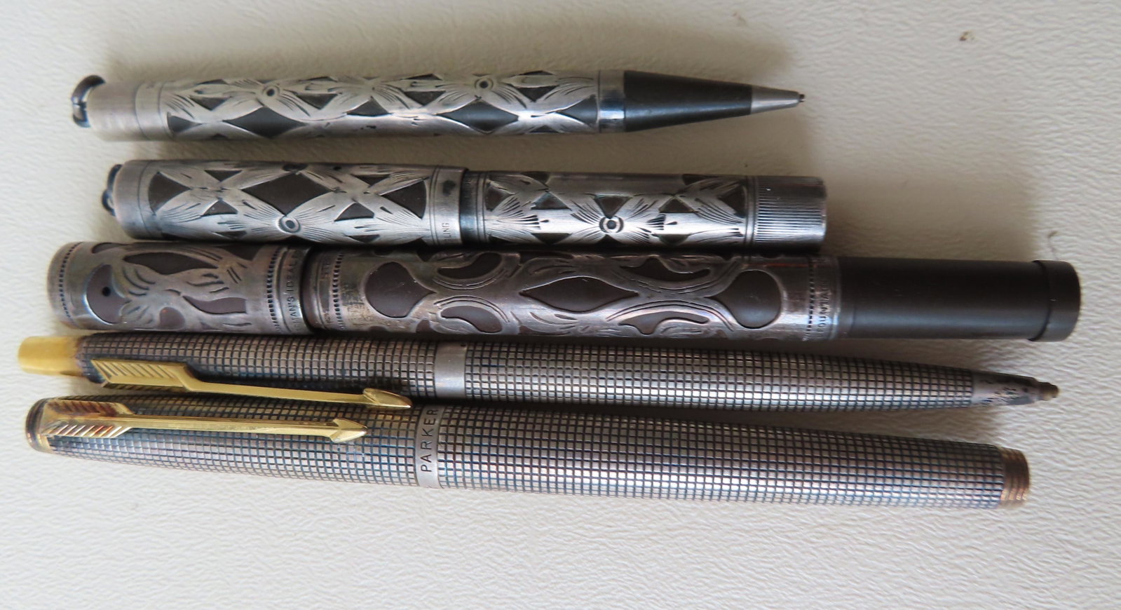 Five sterling silver pen and pencils including:: Five sterling silver pen and pencils including: Waterman's sterling filigree lead pencil 3 34/"L - good condition; Waterman's Ideal sterling filigree fountain pen marked "452 1/2 V" - 3 3/4"L - very g