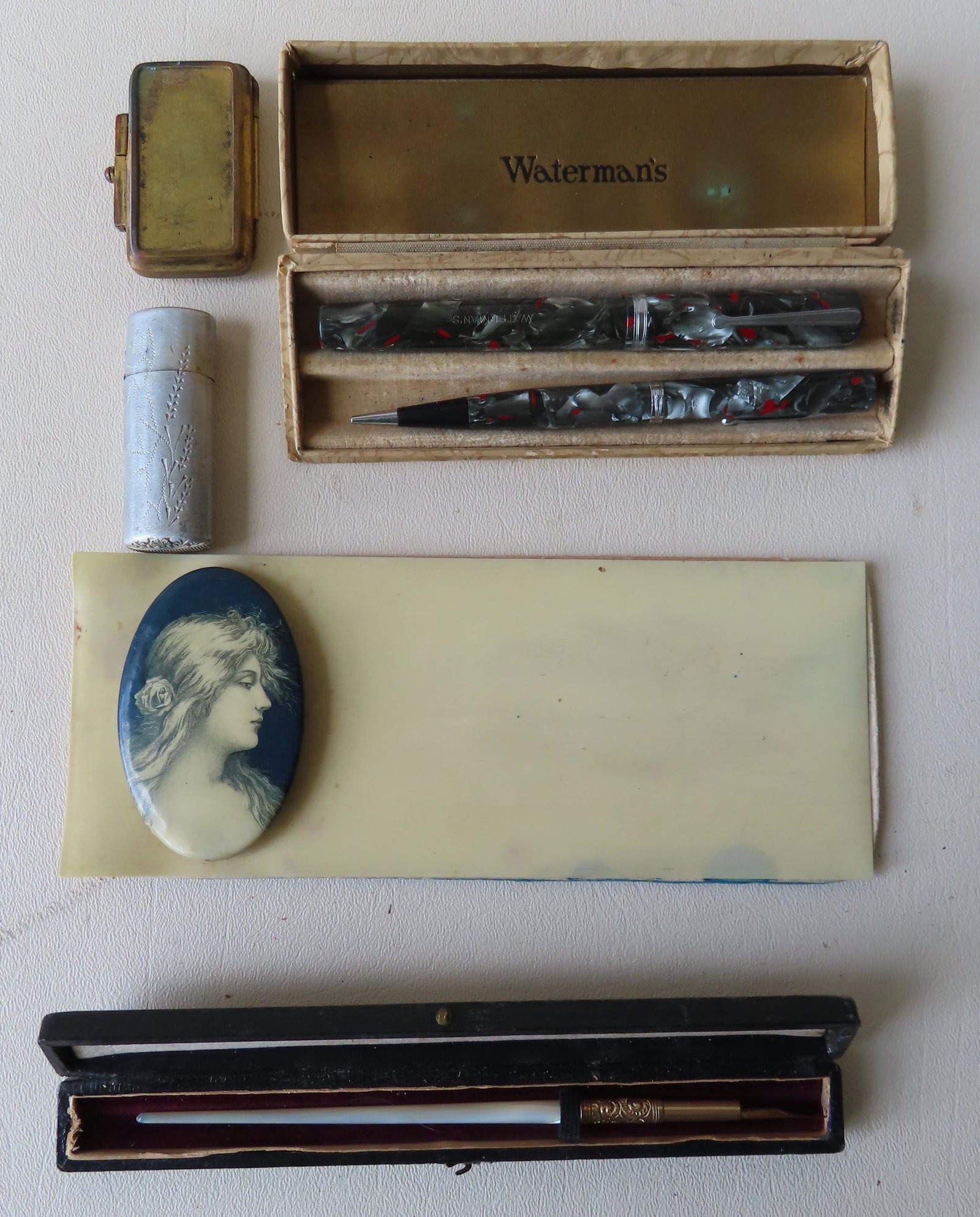 A grouping of writing related vintage collectibles: A grouping of writing related vintage collectibles including: An ink pen with mother of pearl handle and an unmarked gold nib holder, in original box marked "Edward Todd & Co. / Gold Pens / New York" 