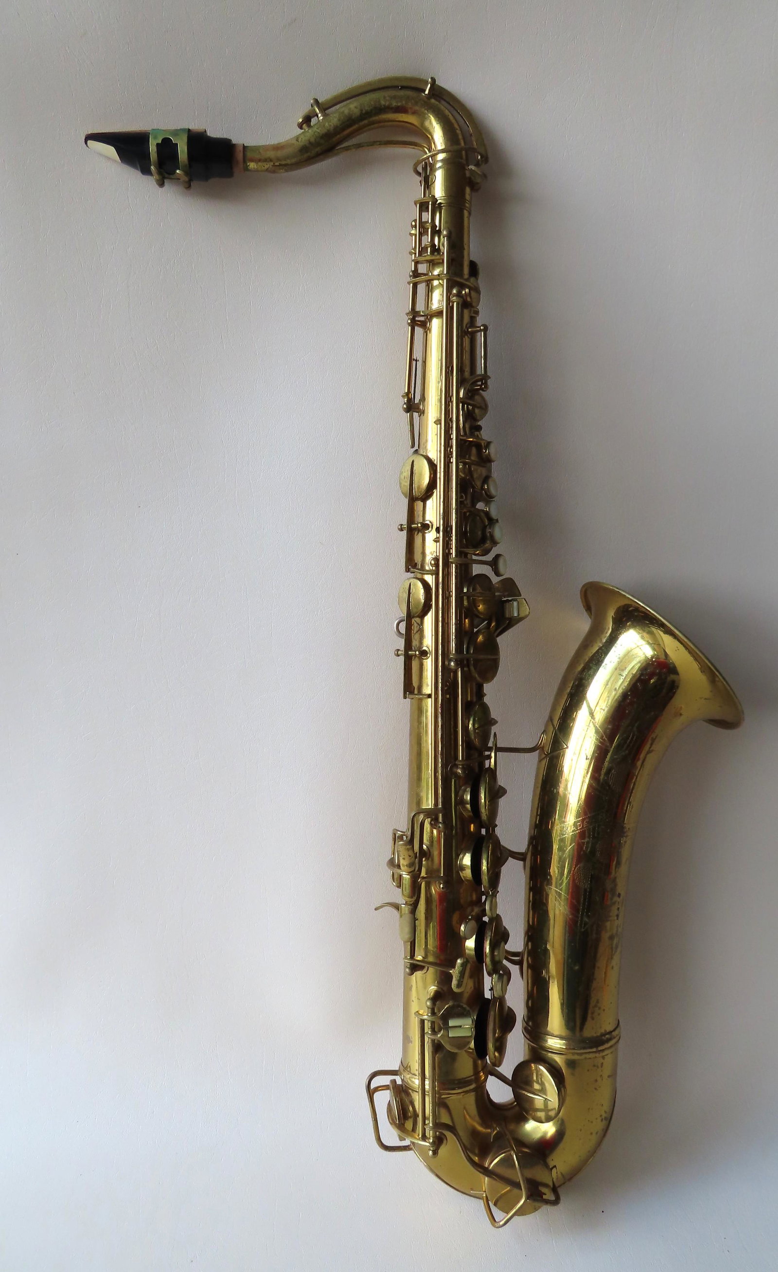 Conn Saxophone, Model 10M: Conn Saxophone, Model 10M, gold lacquered, engraved "Made by C.G. Conn Ltd. / Elkhart Ind. / U.S.A." - serial number below the letter "B" 334736. Some surface imperfection to lacquer, minor dings, but