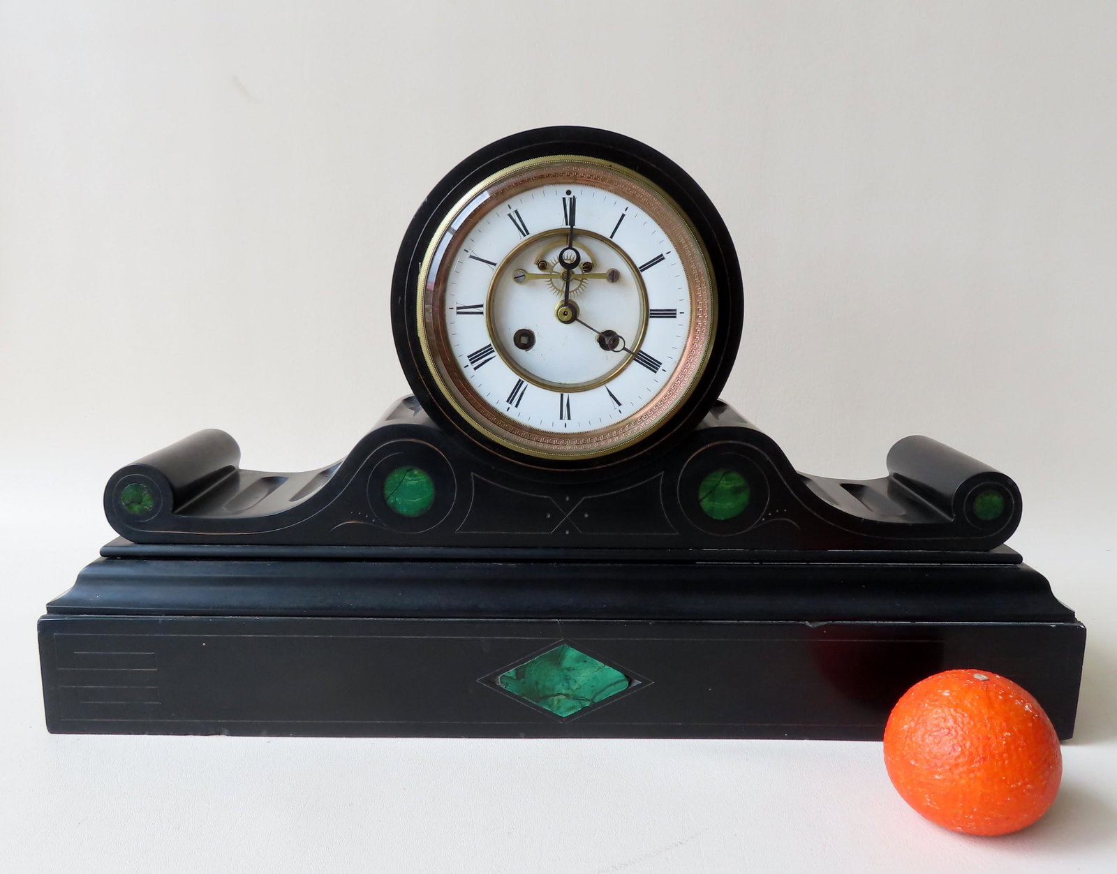 Victorian French black marble (or onyx) mantle clock: Victorian French black marble (or onyx) mantle clock with scrolled sides, open escapement, 19th century. 21"W x 6"D x 12 1/2"H. Tiny chips along edges, else good condition - see photos for details. No