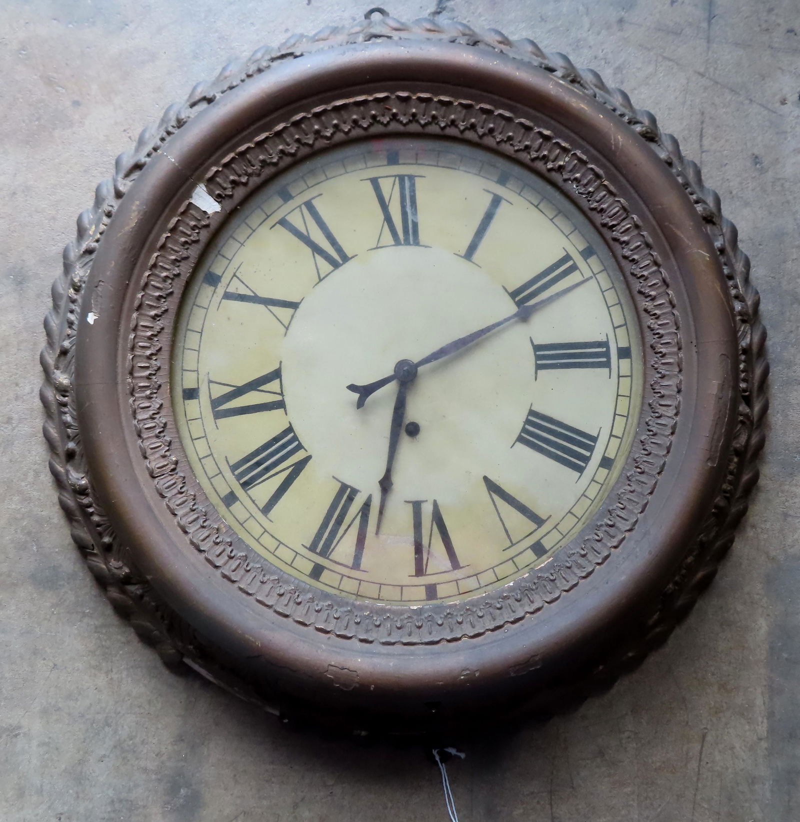 A circular gilt gesso wall clock, key wind with: A circular gilt gesso wall clock, key wind with pendulum. Measures 22 1/4" diameter x 4 1/2" deep. Some gesso losses, appears to be in second gilding, sold as non-working without key.