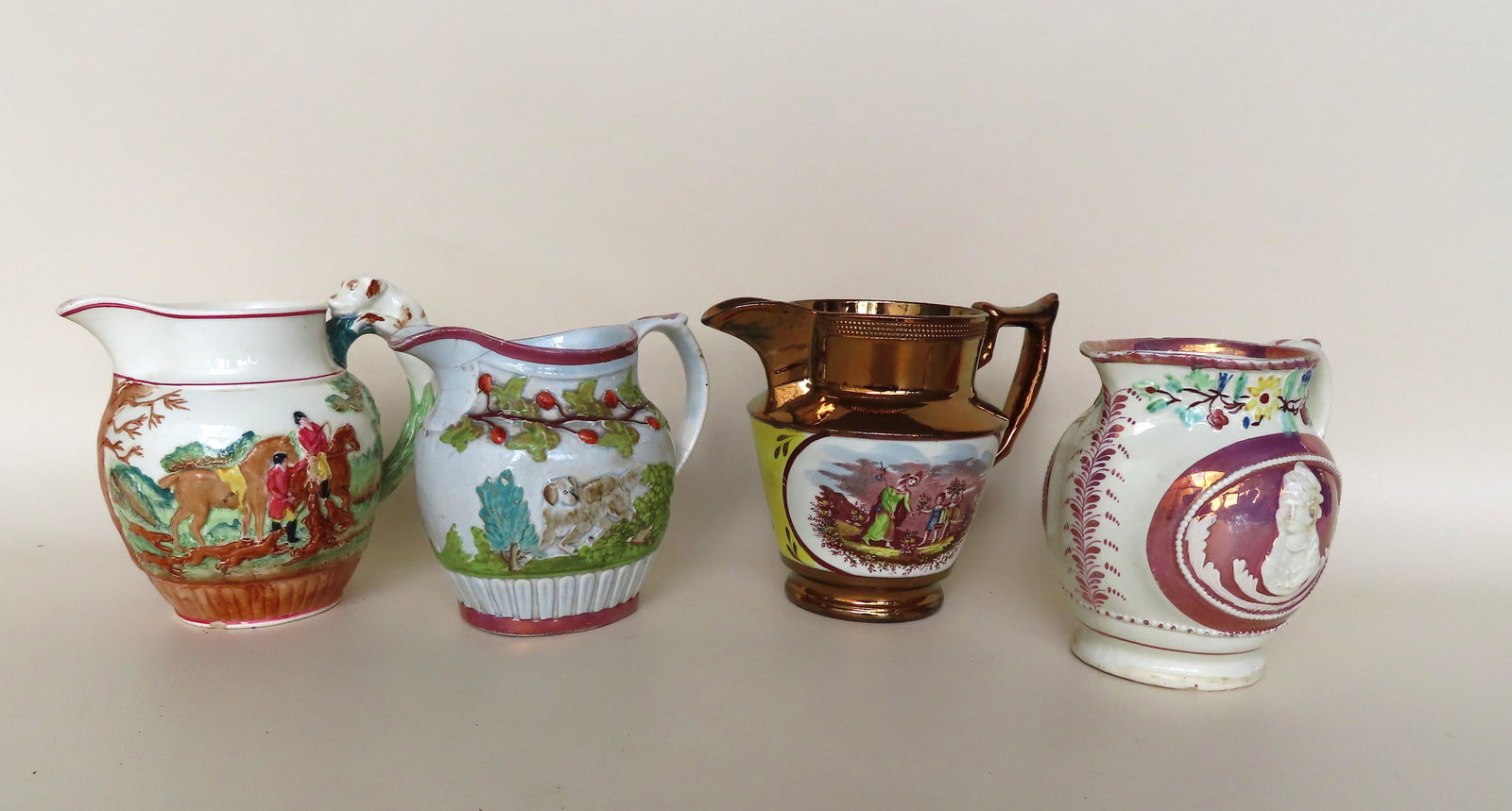 Grouping of 4 early English pitchers including: Grouping of 4 early English pitchers including Wedgewood creamware with hunt scene and hound handle; copper luster with hand colored image of woman and 2 children with flowers; unmarked purple lustrew