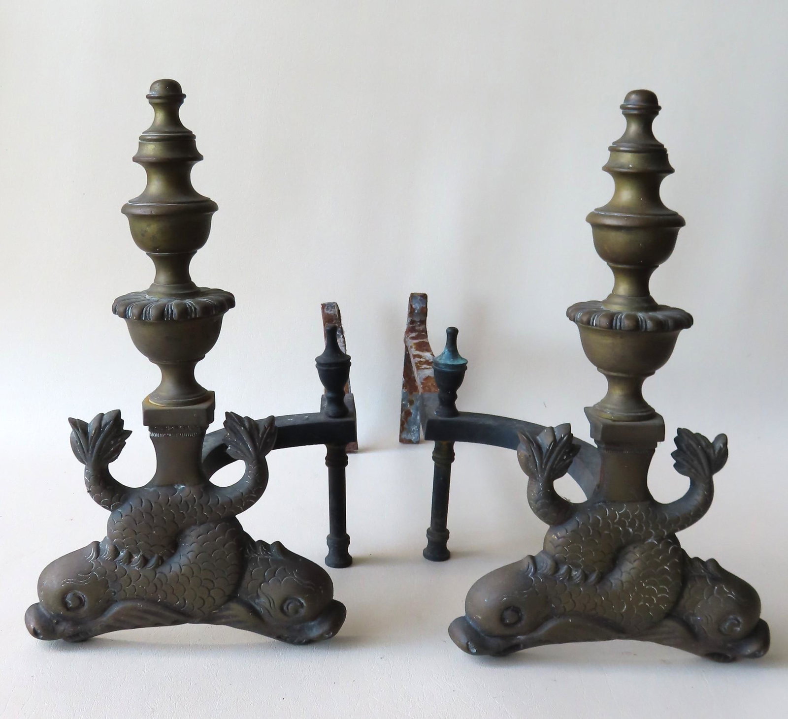 Pair of brass dolphin form andirons with turned posts,: Pair of brass dolphin form andirons with turned posts, late 19th century, very good condition - 16"H x 20"D.