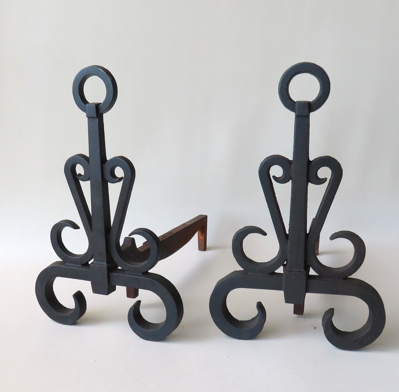 A pair of cast iron Arts & Crafts style andirons signed: A pair of cast iron Arts & Crafts style andirons signed Bennett - very good condition. 15 3/4"H x 10"W x 17"D.