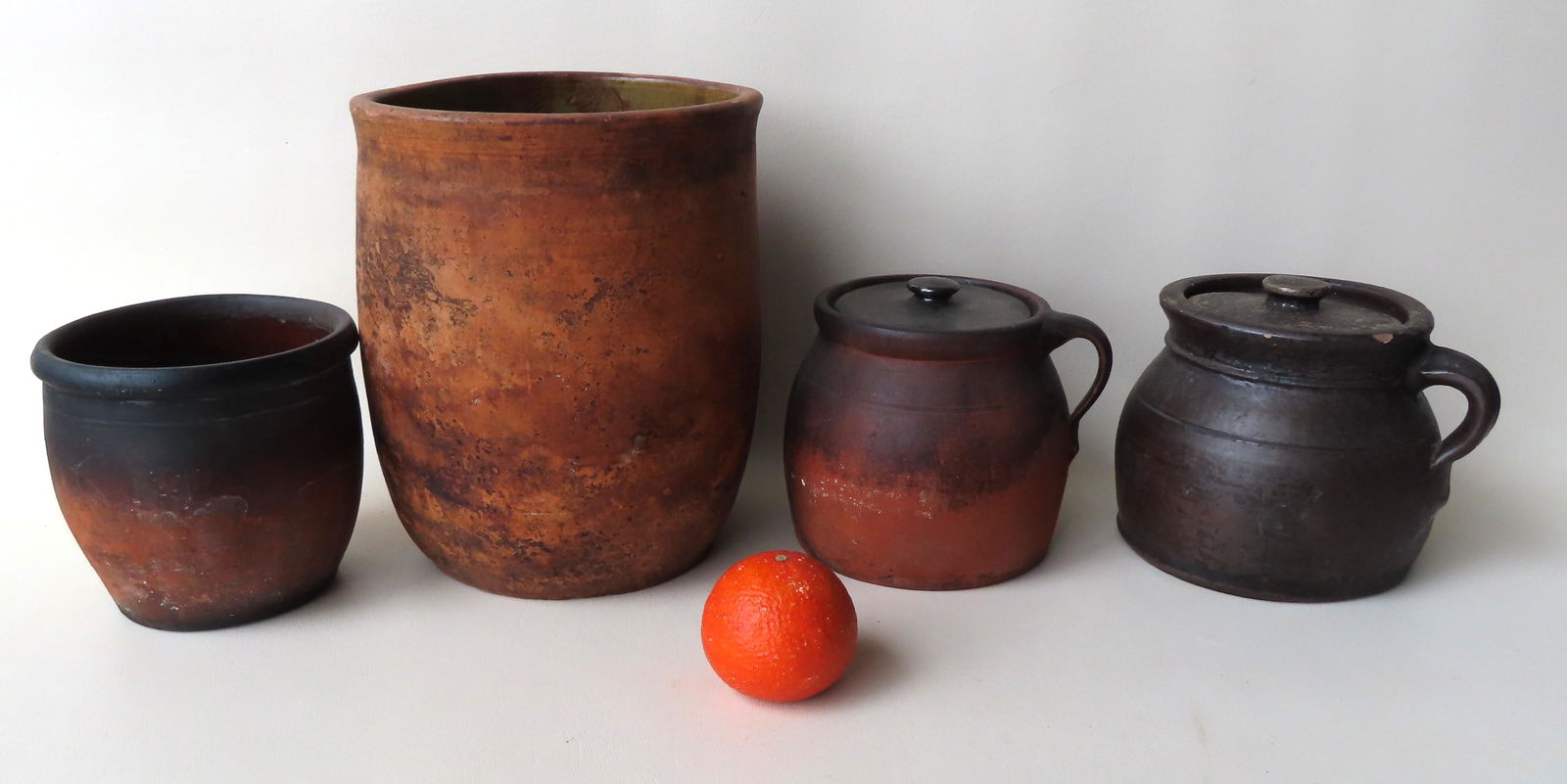 Grouping of 4 redware jars. The largest with chip on: Grouping of 4 redware jars. The largest with chip on edge of base, else good condition - 11"H x 9" diameter; the other 3 with evidence of oven use, but no damage and are in very good condition. All mi
