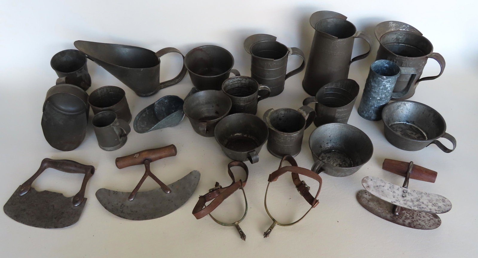 Large grouping of vintage tinware.: Large grouping of tinware including cups, grain scoops, pitchers,food choppers, and a pair of old spurs. Most late 19th to early 20th century and in good condition. See photo for more details.