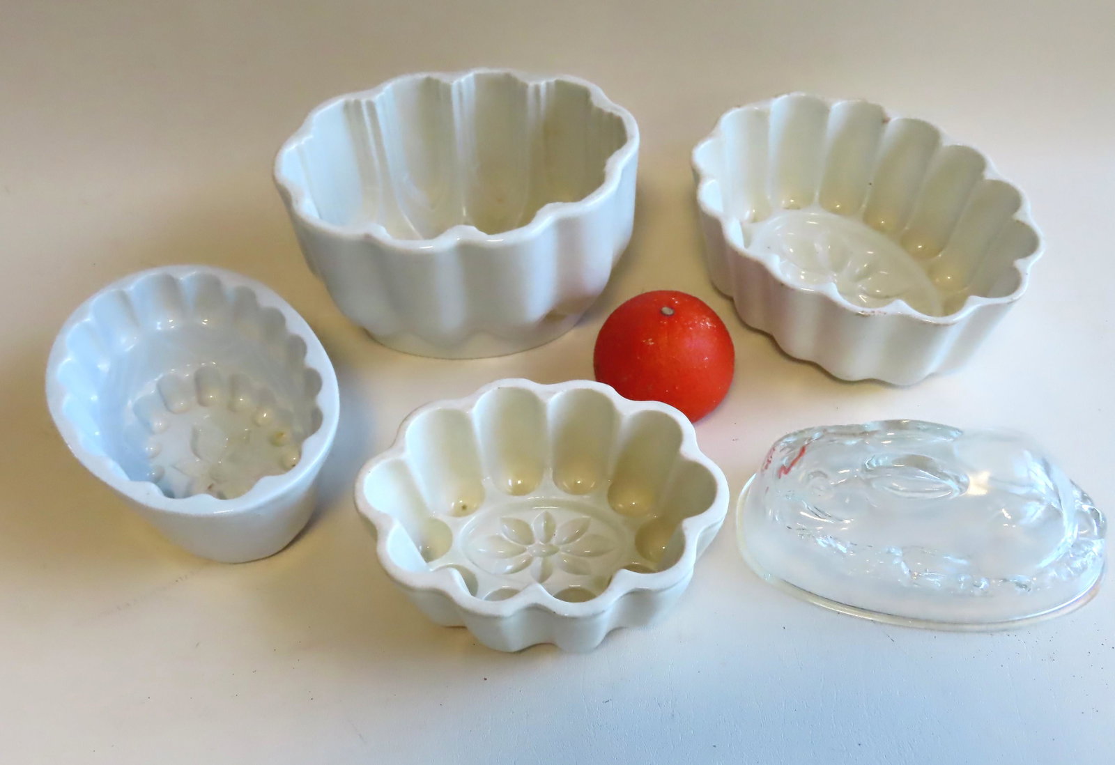 Grouping of 5 vintage pudding molds.: Grouping of 5 vintage pudding or Jello molds including: 4 in white ironstone, 2 of these signed Mintons England - the largest measures 7 5/8"W x 6"D x 4 3/4"H and in very good condition, the smallest 