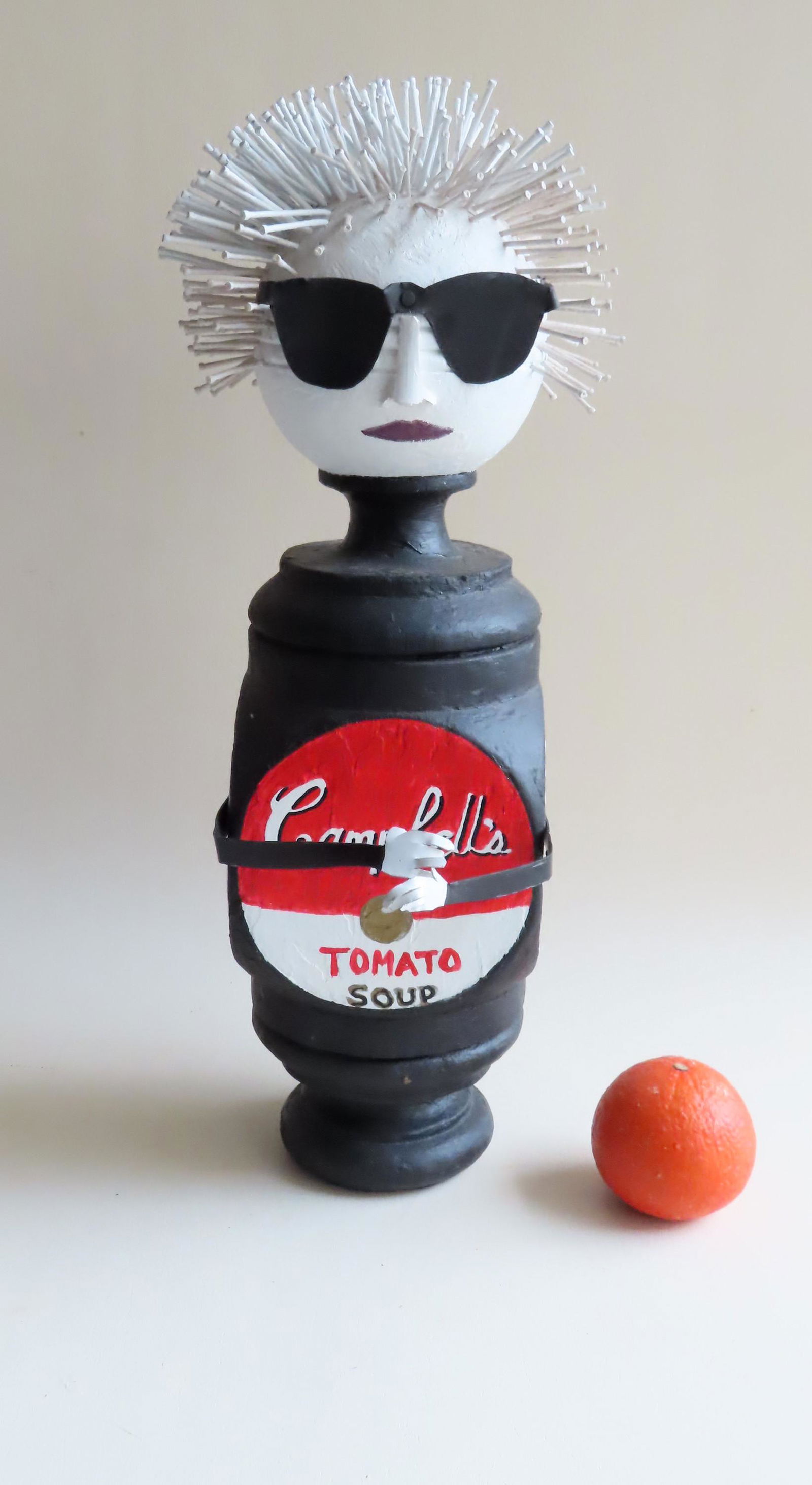 A modernistic 21st century sculpture.: A modernistic 21st century sculpture constructed from the top section of a 19th century newel post and hand painted to form the image of a stylized lady. Note the hair constructed of nails. Note one p