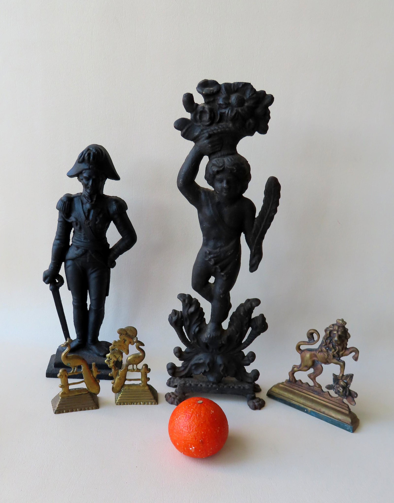 Grouping of 5 early iron and brass objects: Grouping of 5 early iron and brass objects including: Cast iron door stop in the form of a colonial man, possibly George Washington - old repair to head - 14"H; a cast iron figural fireplace ornament 