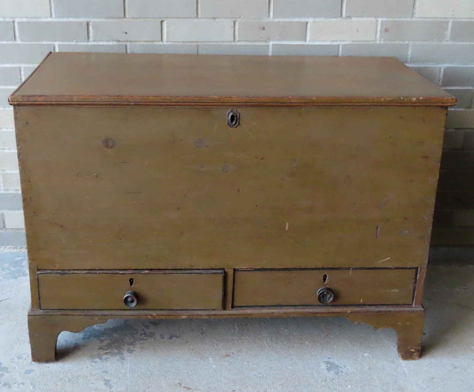 A very fine putty-green colored blanket chest having 2: A very fine putty-green colored blanket chest having 2 lower drawers mounted on original bracket base and original iron handles on sides. The interior with rattail hinges and secret drawer - both draw