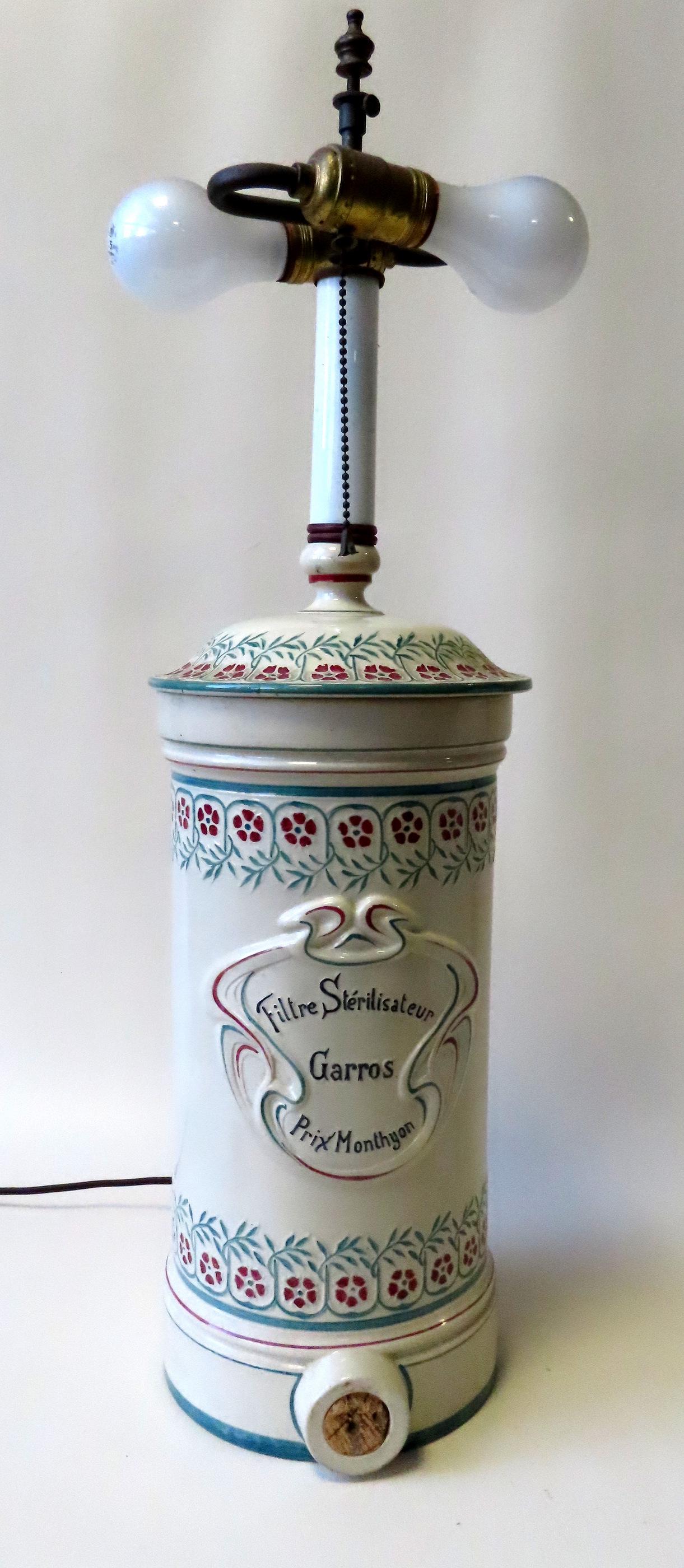 A French sterilizer porcelain jar, converted to lamp,: A French sterilizer porcelain jar, converted to lamp, 19th century in good condition. Measures 26"H x 8"W.