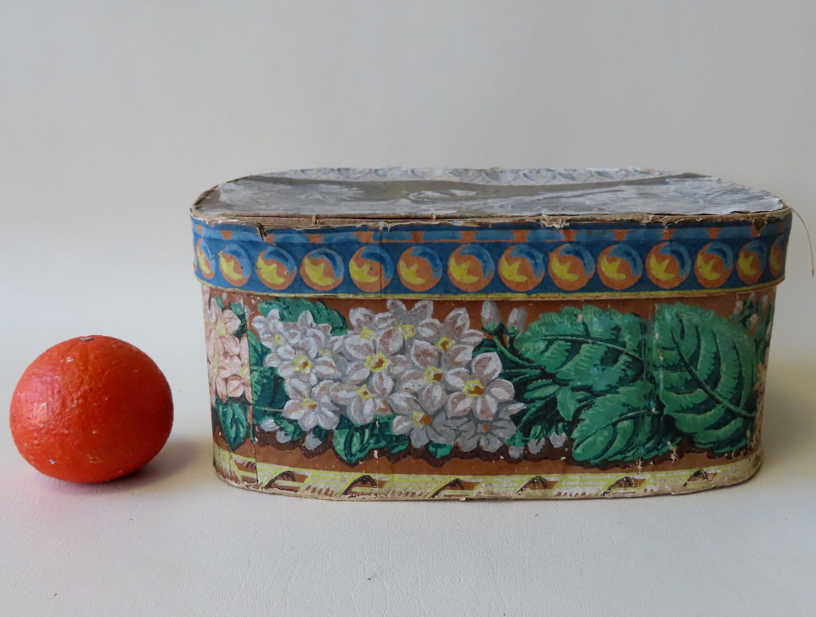 A colorful wall papered band box decorated with leaves (1 of 6)