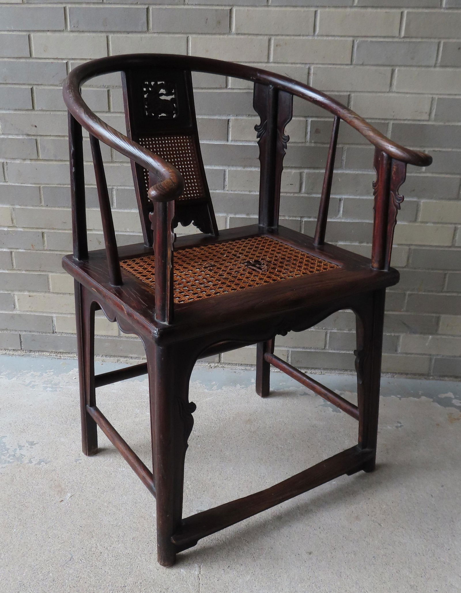 An untouched Chinese horseshoe back armchair having a (1 of 14)