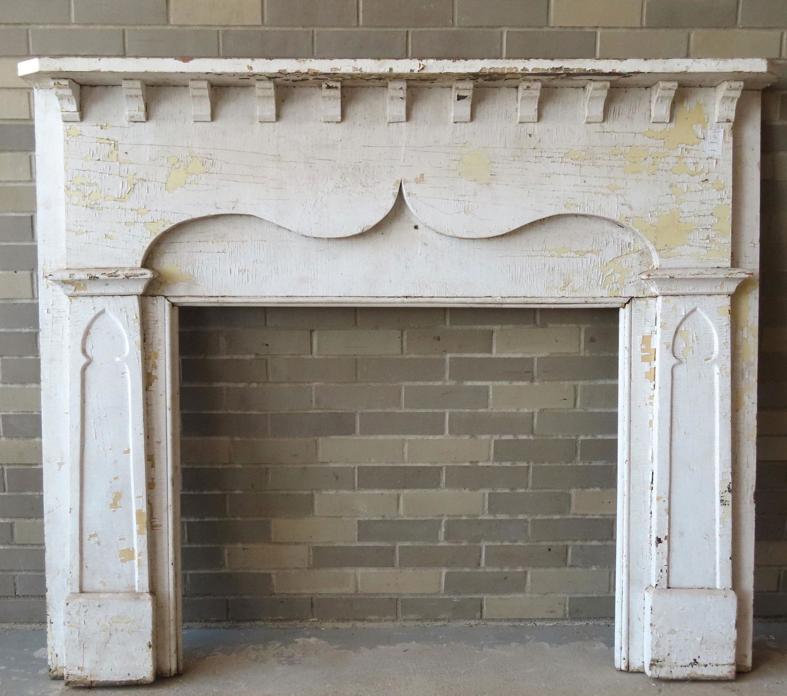 A fireplace mantel having a shelf supported by a (1 of 9)