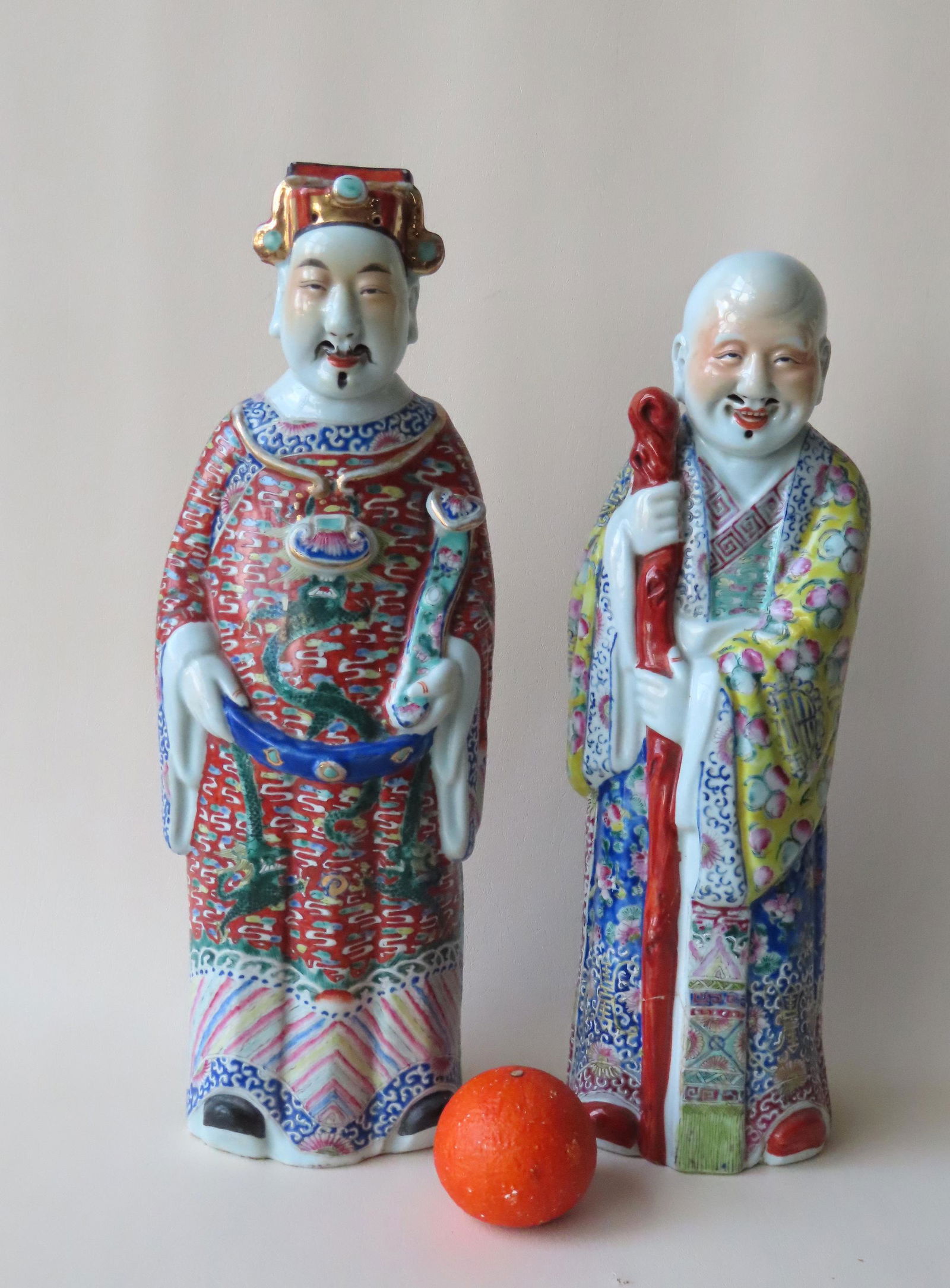 Pair of large Chinese porcelain sculptures of 2 elderly: Pair of large Chinese porcelain sculptures of 2 elderly gentleman wearing colorful hand painted costumes. The first with impressed signature on base and paper sticker marked "God of Wealth" - 19 1/4"H