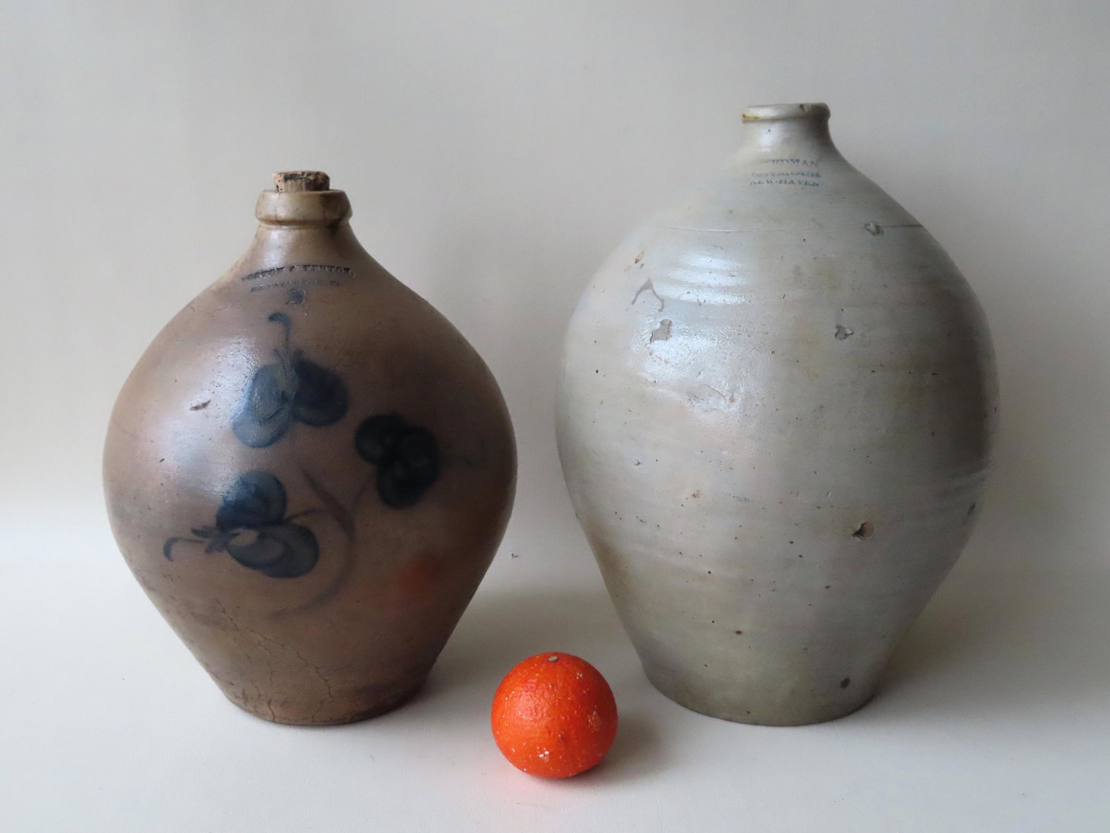 Two stoneware ovoid jugs. The first, probably 3 gallon,: Two stoneware ovoid jugs. The first, probably 3 gallon, with the impressed mark of Stedman Seymour - New Haven and having cobalt blue brushed highlights at handle terminals - several pebble bursts, 2 