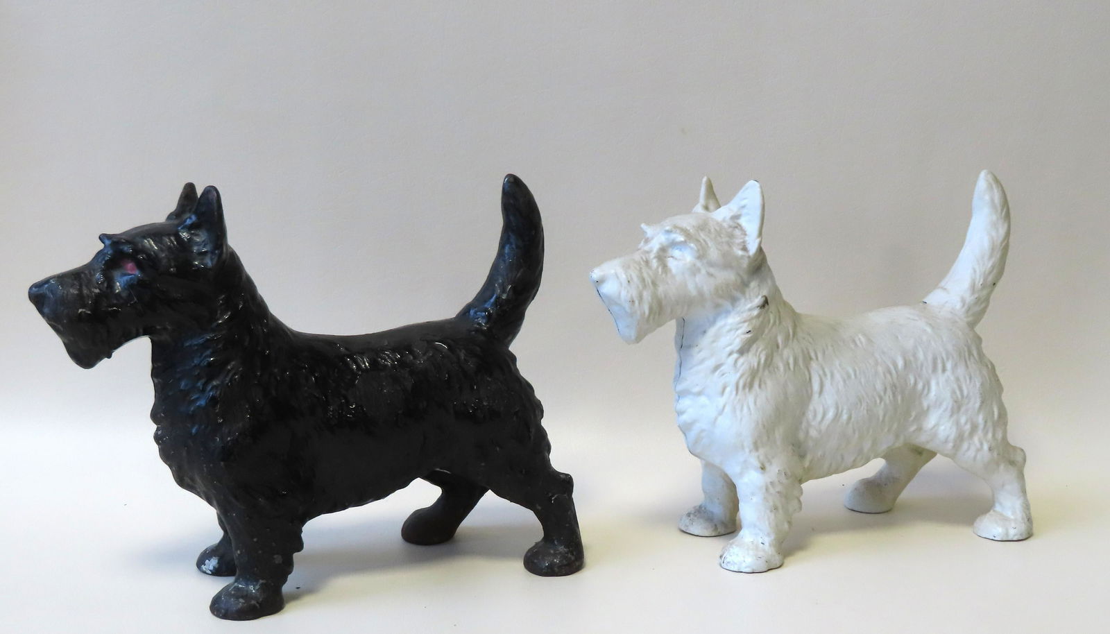 Two cast iron Scottie dog door stops, one in original (1 of 7)