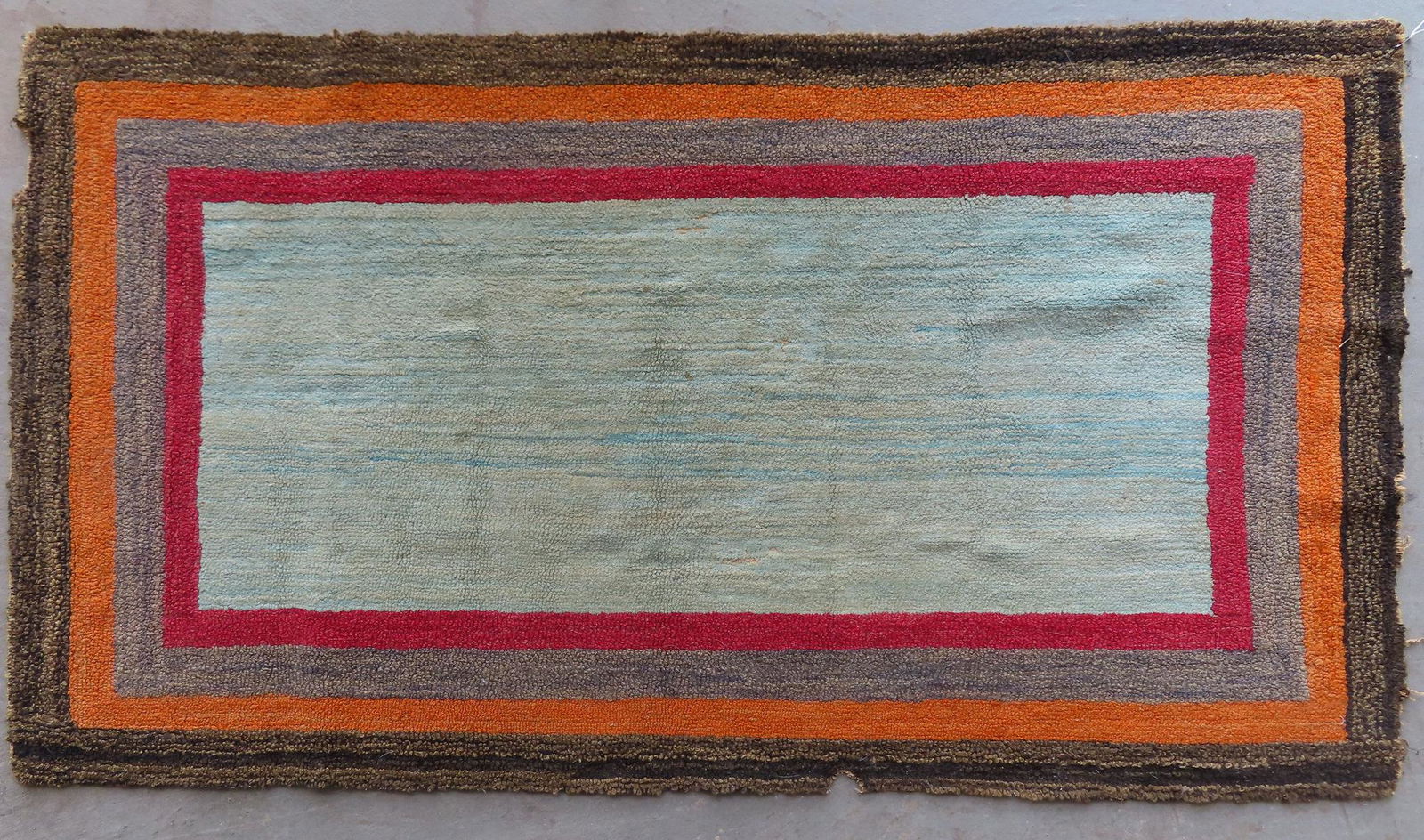 Hooked rug with a striated center surrounded by 6 (1 of 4)