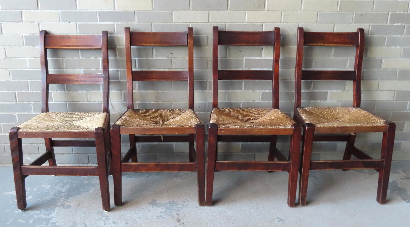 Set of 4 matching French dining chairs in mahogany with: Set of 4 matching French dining chairs in mahogany with cross stretchers and rush seats. All in very good condition including the rush. Circa 1800. Each measures 18"W x 15 1/2"D x 18"H (top of seat) x