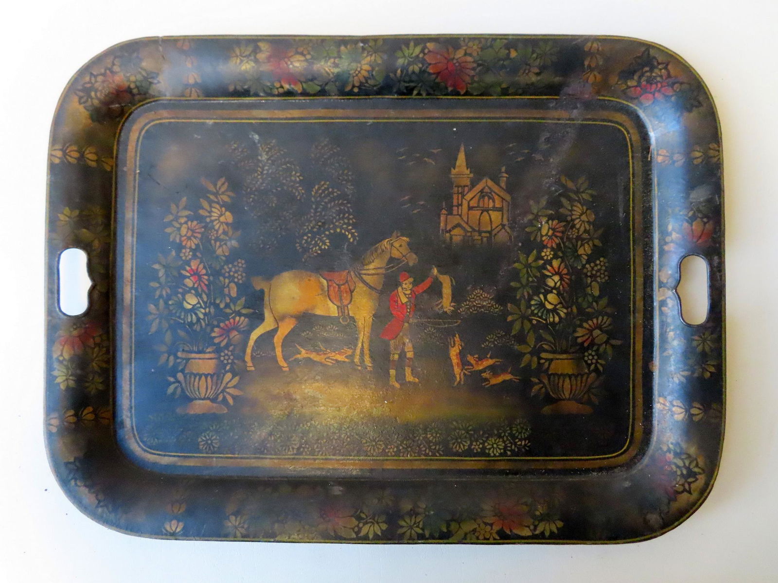 A stenciled toleware tray depicting the end of a horse (1 of 4)