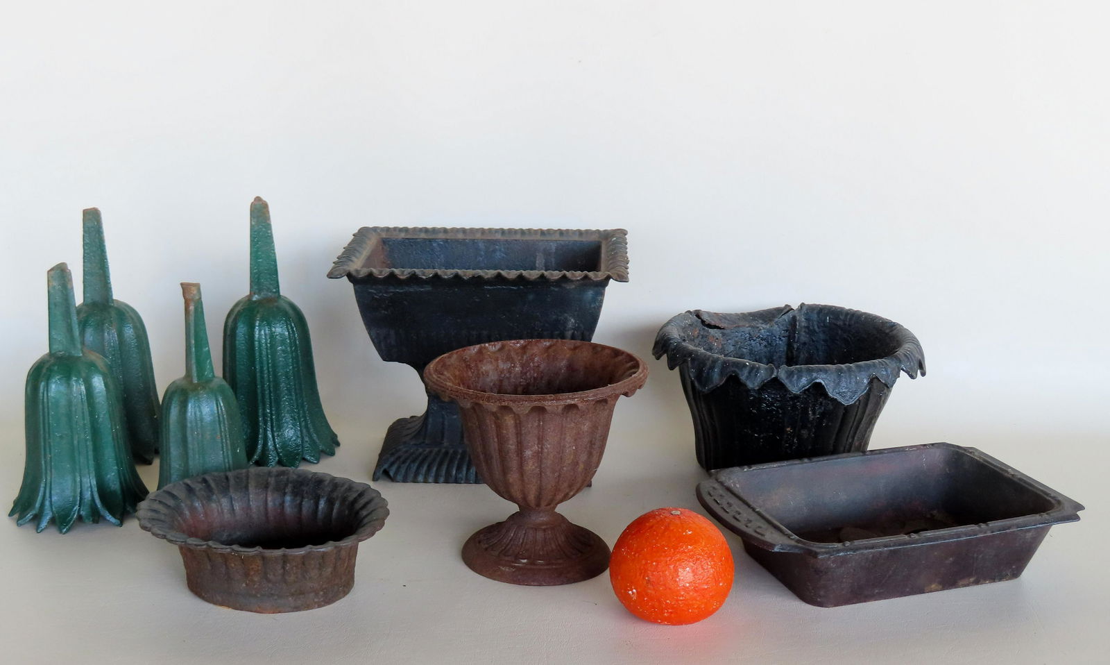 A grouping of small iron planters and other objects, 19th century, including: 4 flower shaped (1 of 9)