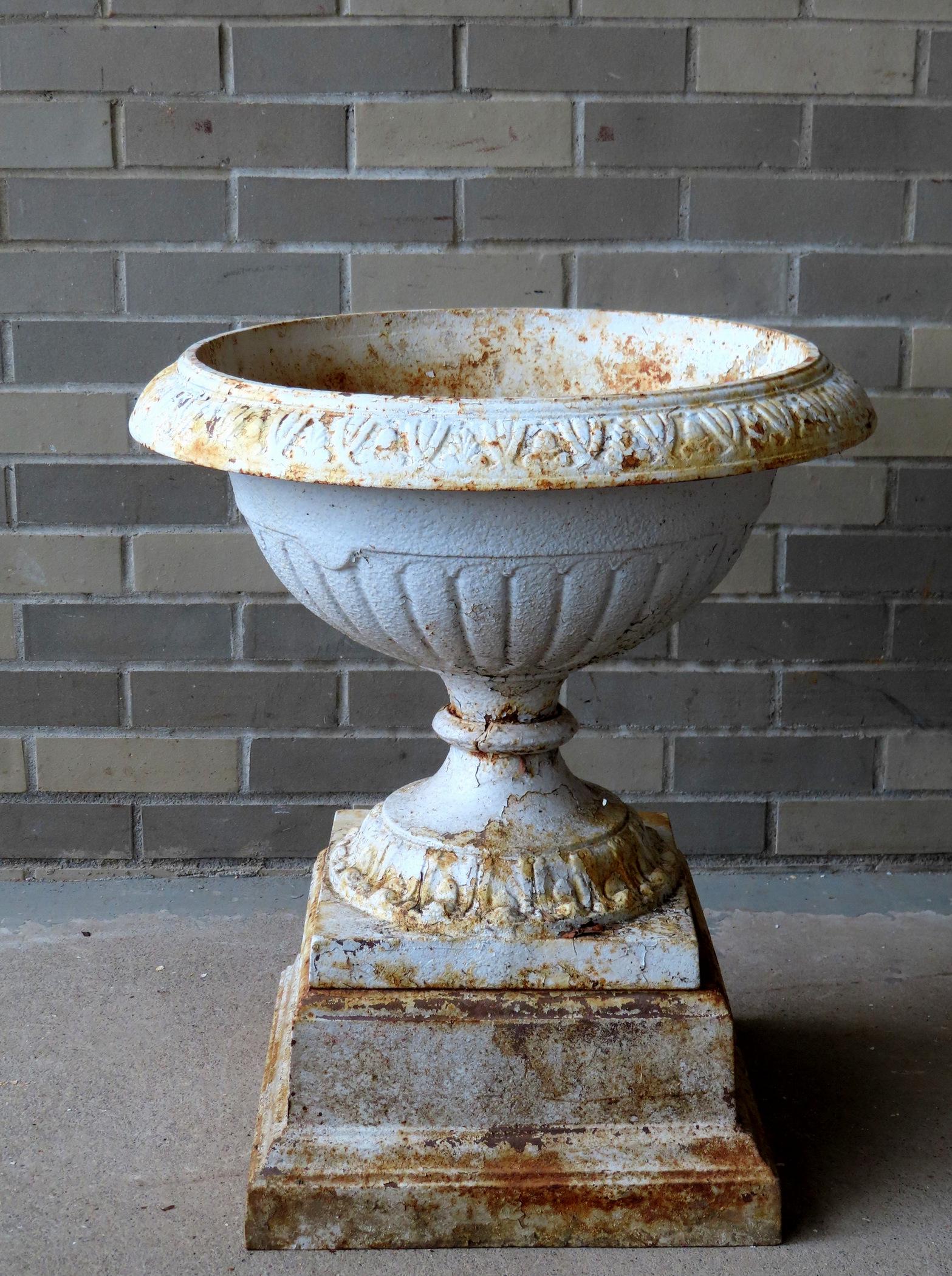 A cast iron garden urn with 4 removable sections. Missing handles and loss along edge of rim. 19th (1 of 6)