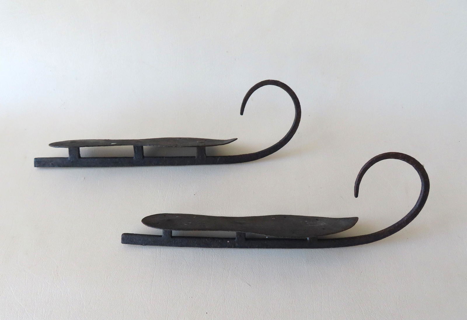 A pair of hand forged iron ice skates, early 19th century. Both in very good condition. Measures 14 (1 of 4)