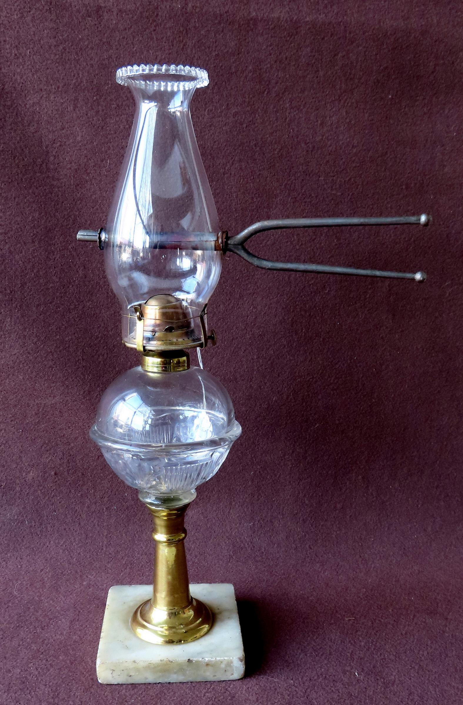 An unusual oil lamp having a pattern glass oil font with an embossed American shield, mounted on a (1 of 4)