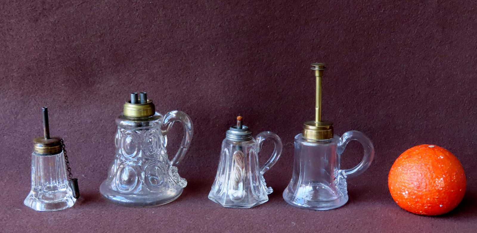 Four small fluid lamps, probably New England, 19th century. All in pressed glass and 2 with applied (1 of 7)