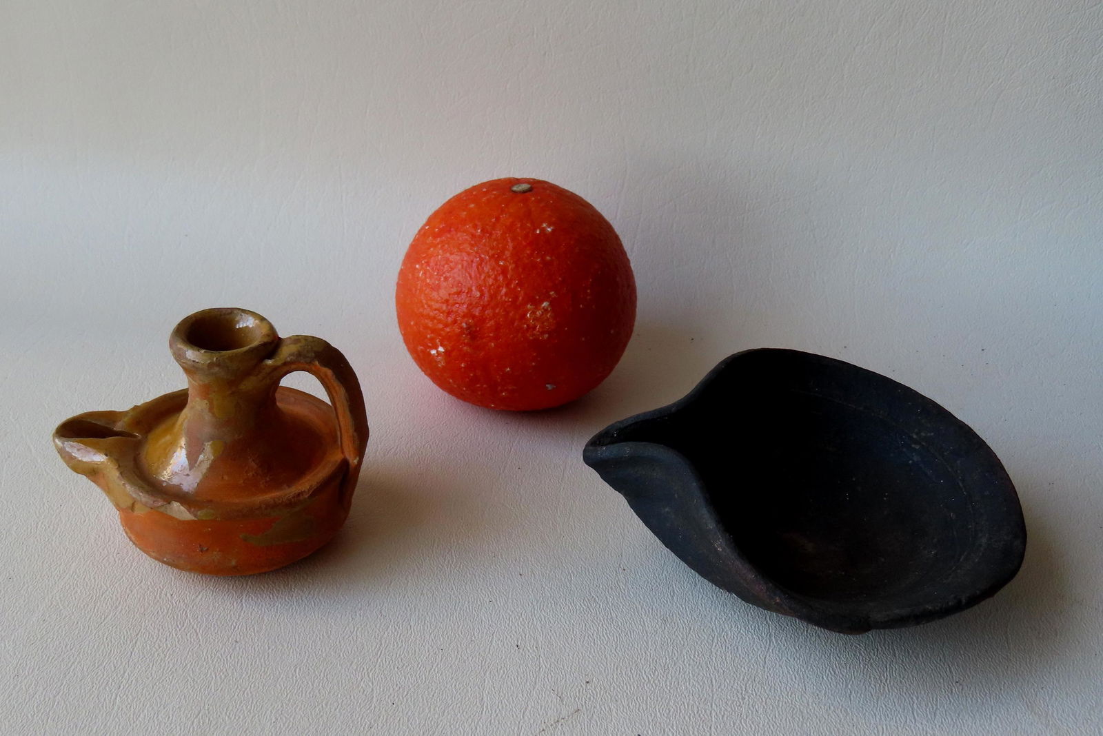 Two small earthenware fat burning lamps. The first a light glazed redware lamp, probably (1 of 9)
