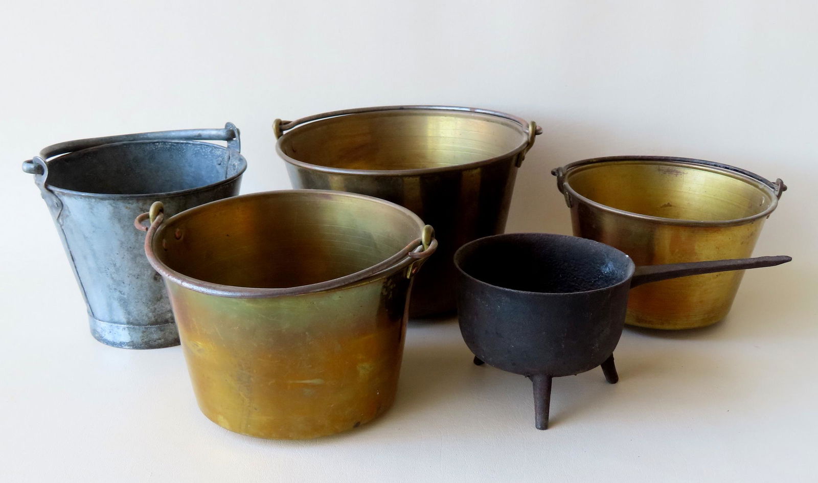A grouping of  4 buckets and 1 iron posnet. Three buckets in brass with forged iron handles in (1 of 8)