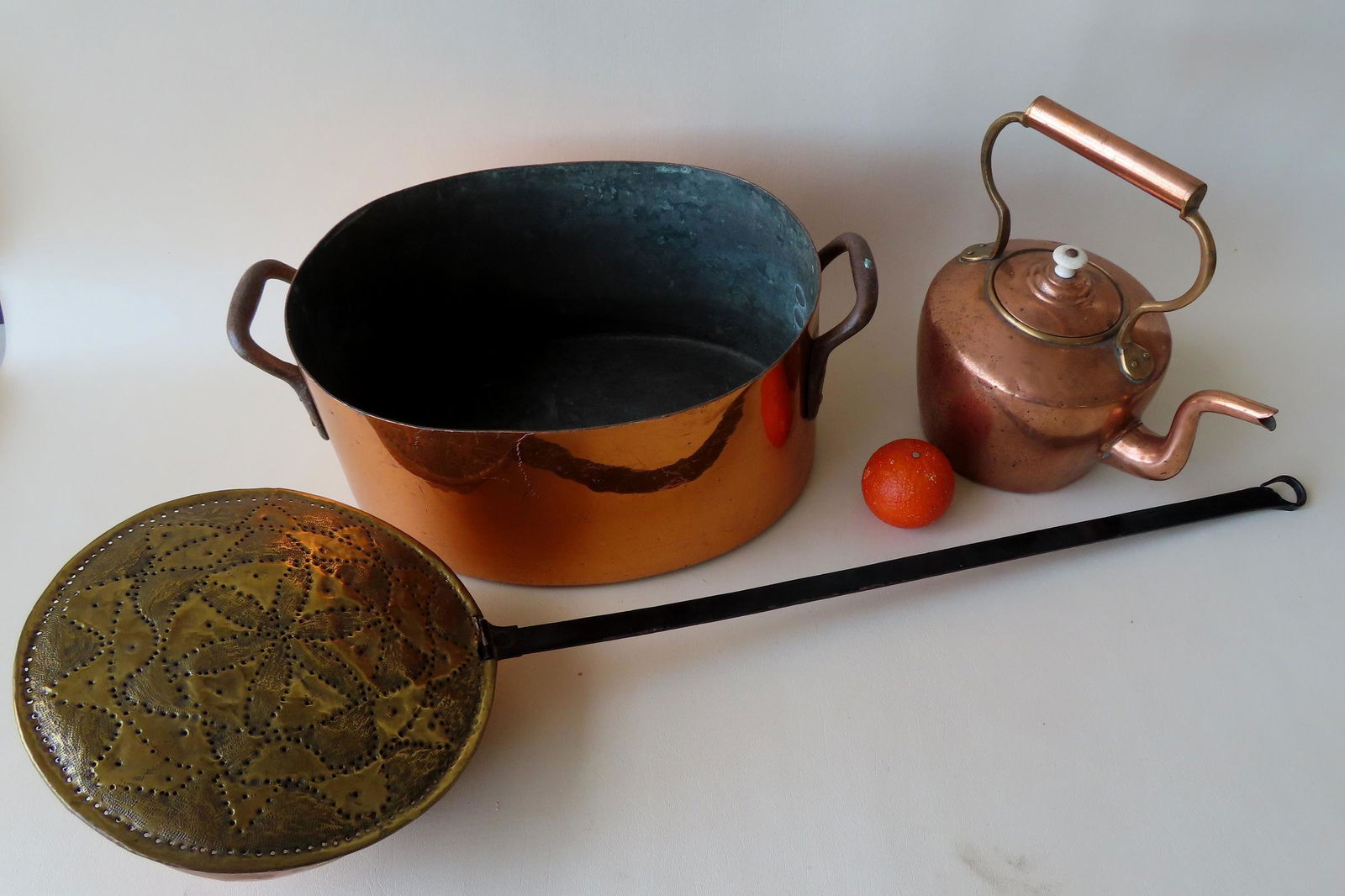 Three brass  and copper hearth items including: A hand hammered brass bed warmer decorated on the (1 of 12)