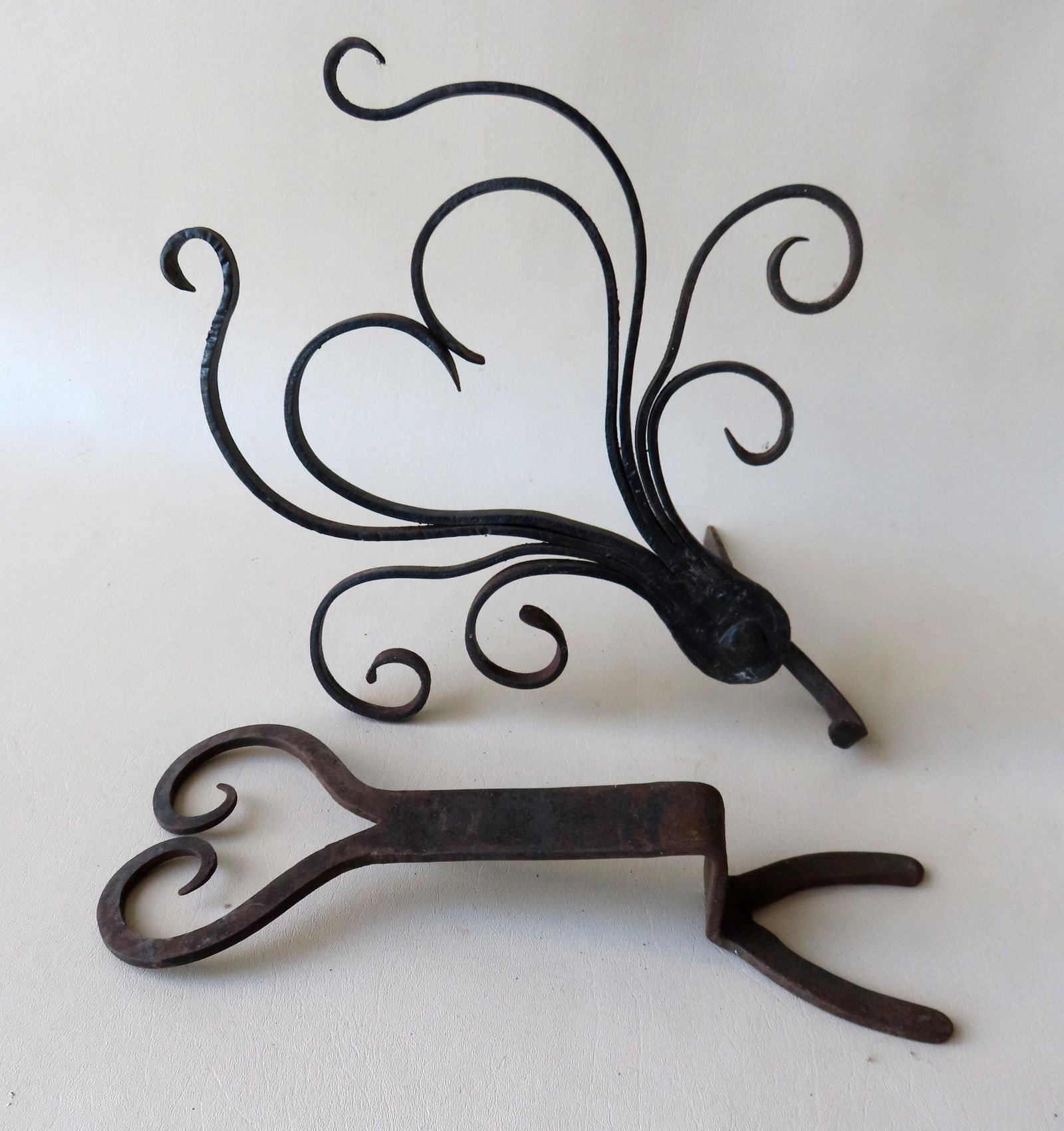 Two hand forged iron collectibles. The first, an iron boot jack with heart shaped terminal - mid (1 of 6)