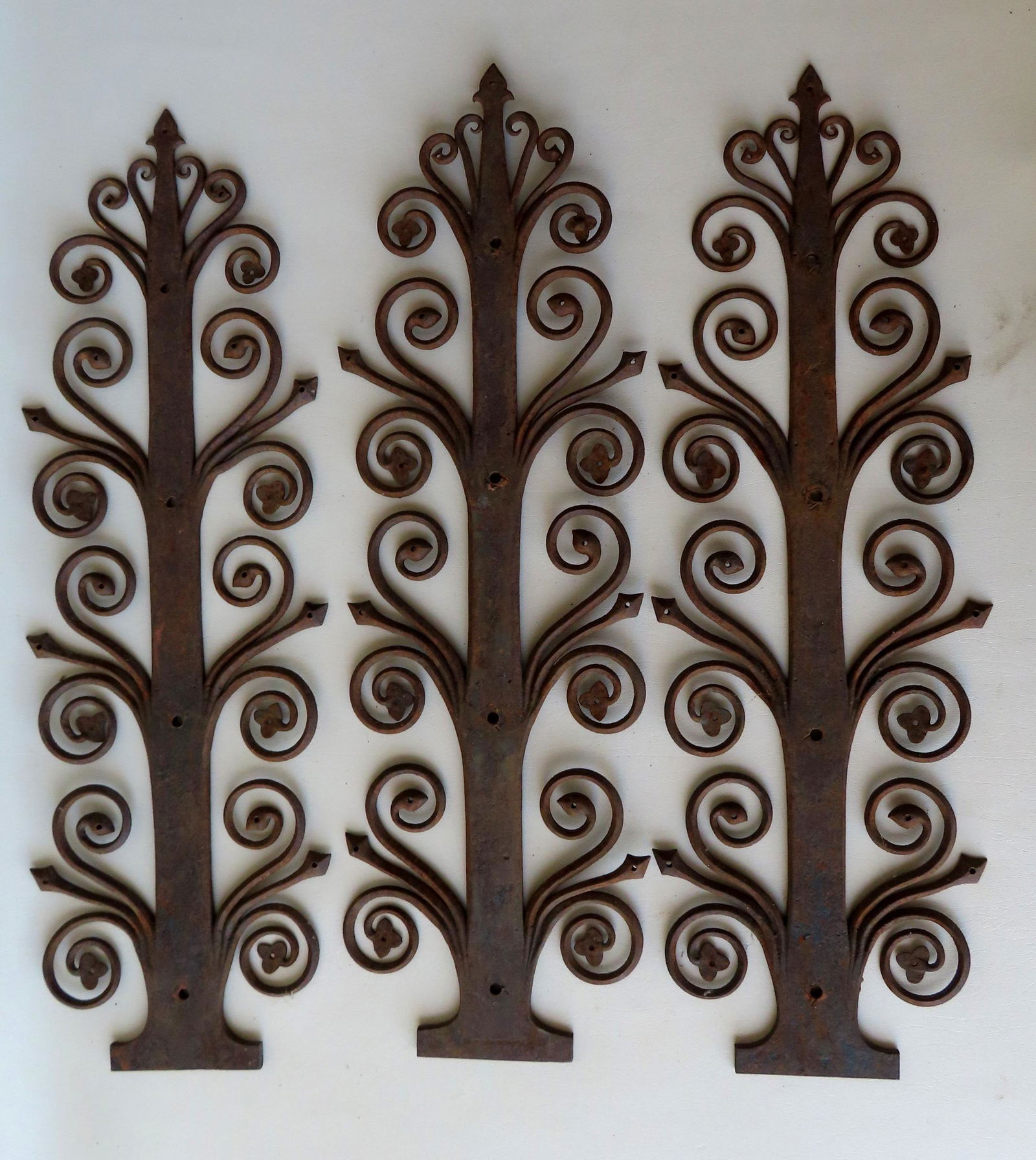 An artistic set of 3 matching iron hinges with multiple scrolled ornaments extending from central (1 of 6)
