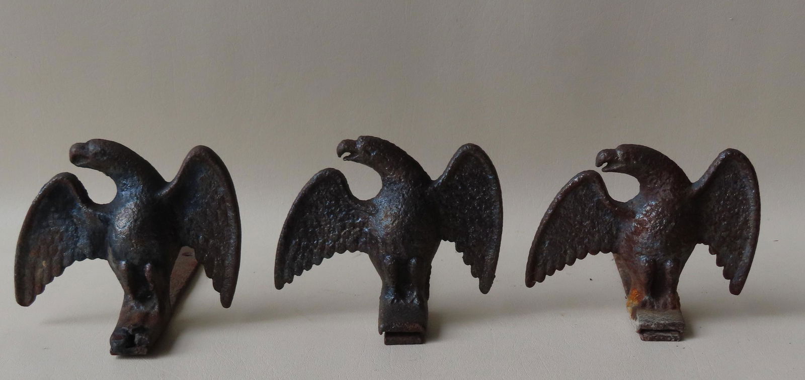 Three cast iron spread wing eagle snow birds, 19th century. All with use wear in old black paint. (1 of 5)