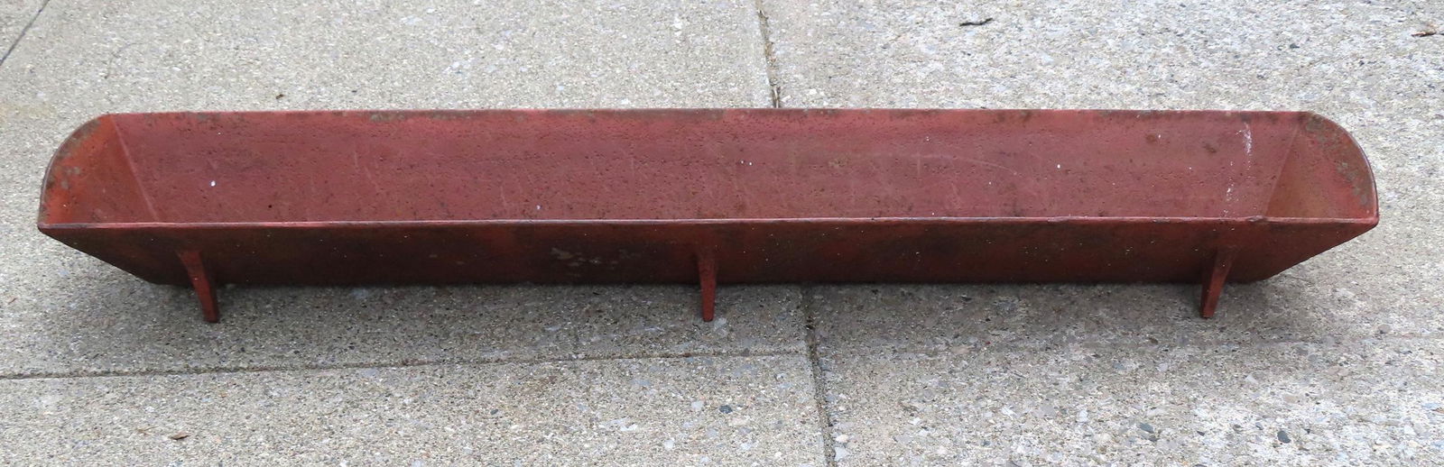 A cast iron hog's feeding trough on footed base. Very good condition. Measures 60 1/2"L x 10 1/2"W x (1 of 6)