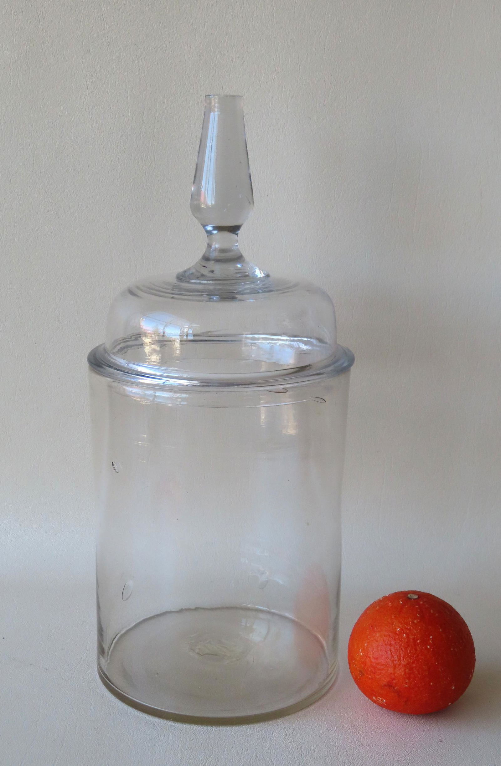 A large free blown apothecary jar with open pontil scar and having a dome shaped lid with and (1 of 3)