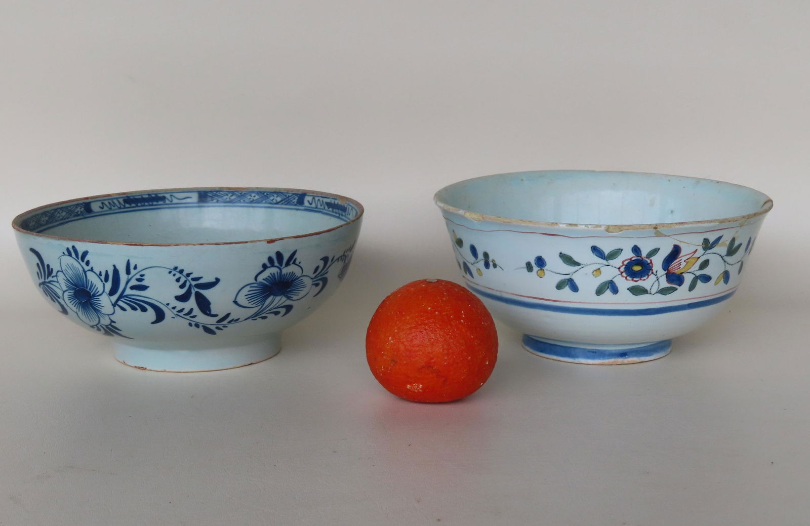 Two early European tin glazed hand painted bowls on footed base. One decorated with colorful flowers (1 of 9)