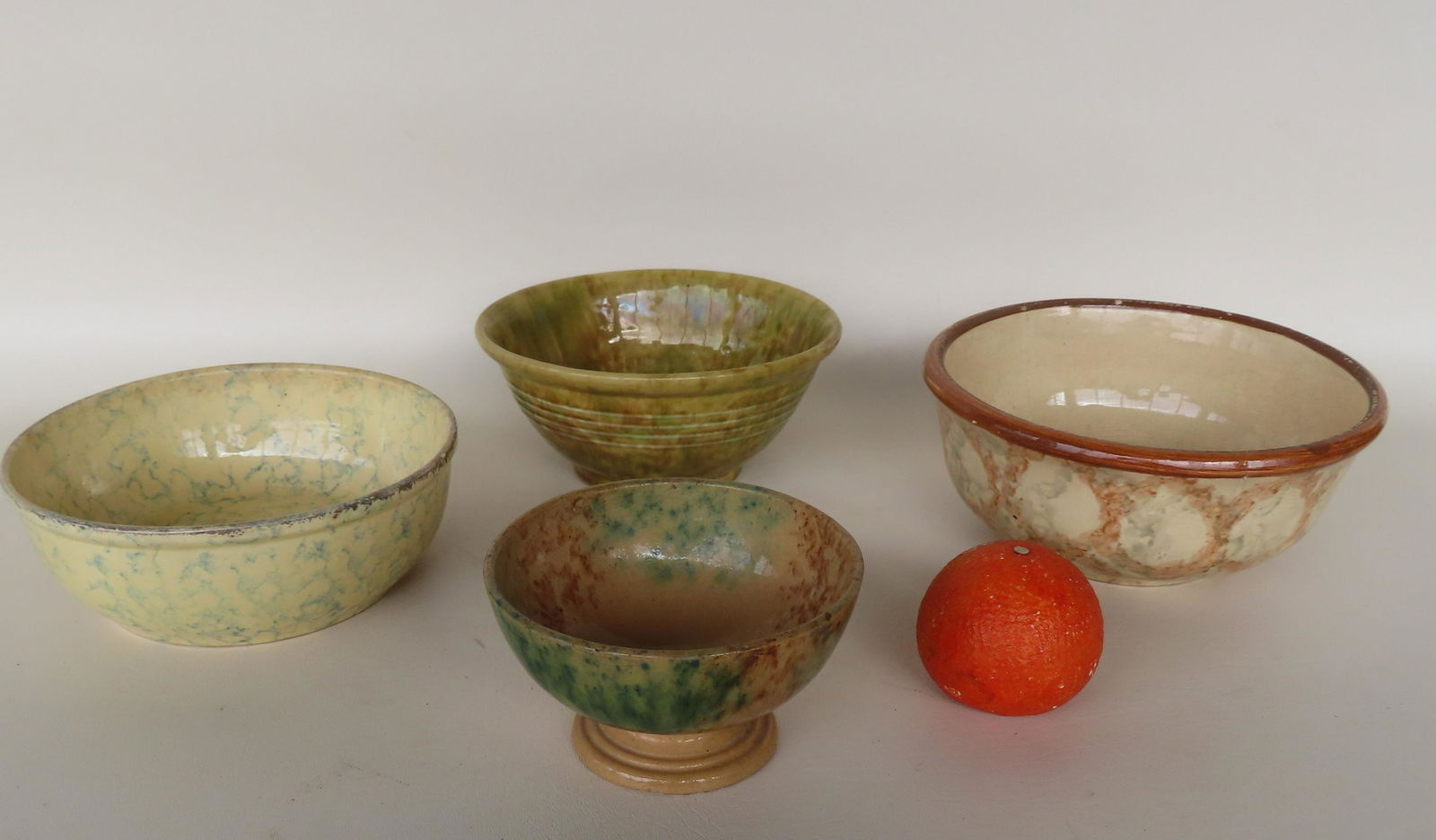 A grouping of 4 spongeware mixing bowls, various colors, ranging in size from 5 5/8"H x 3 1/4"W (1 of 9)