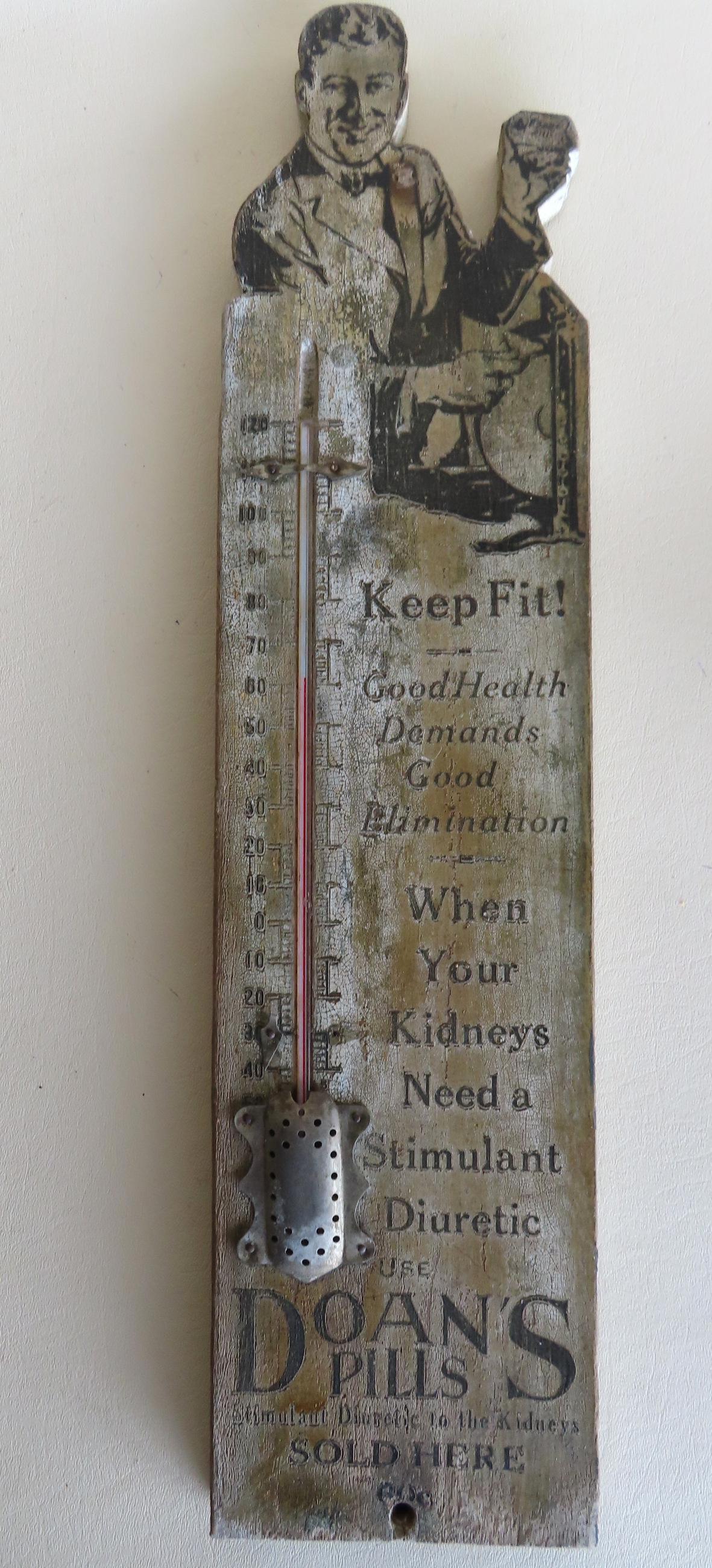 A stenciled wooden advertising thermometer for Doan's Pills. Black on off-white ground. Some paint (1 of 4)