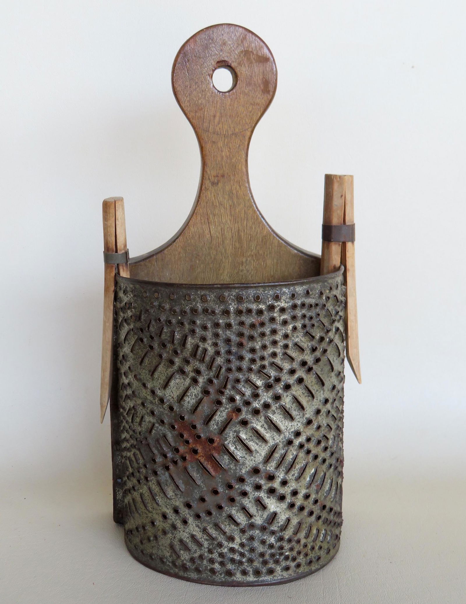 A country pierced tin wall hanging cheese grater with lollipop handle, 19th century. Sold with 2 (1 of 5)